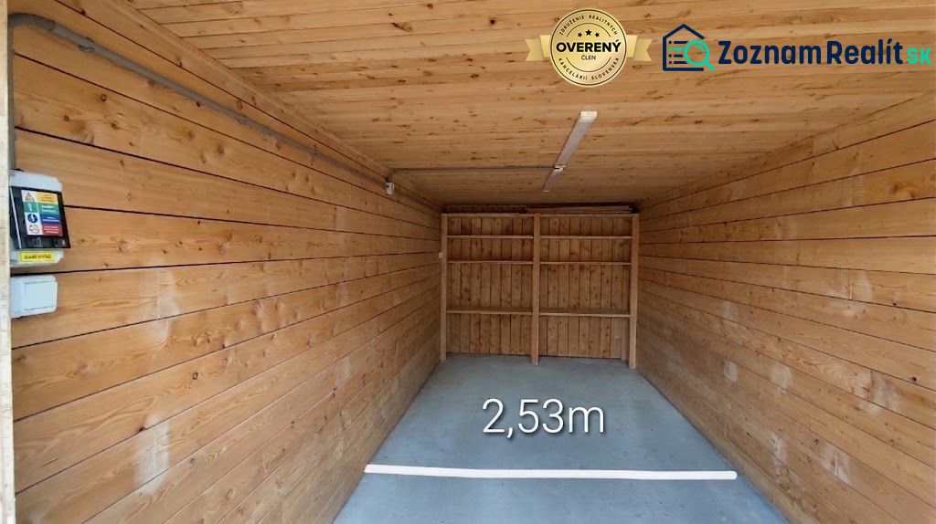 A closed space with a floor and walls with a wooden decor, width 2.53 meters.