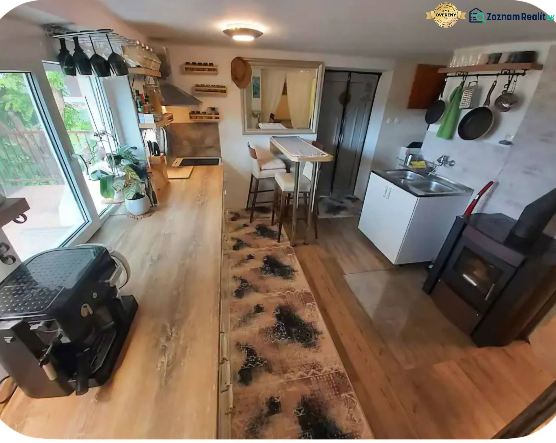 A kitchen in a family house with a wooden decor floor, view of the stove and dishes.