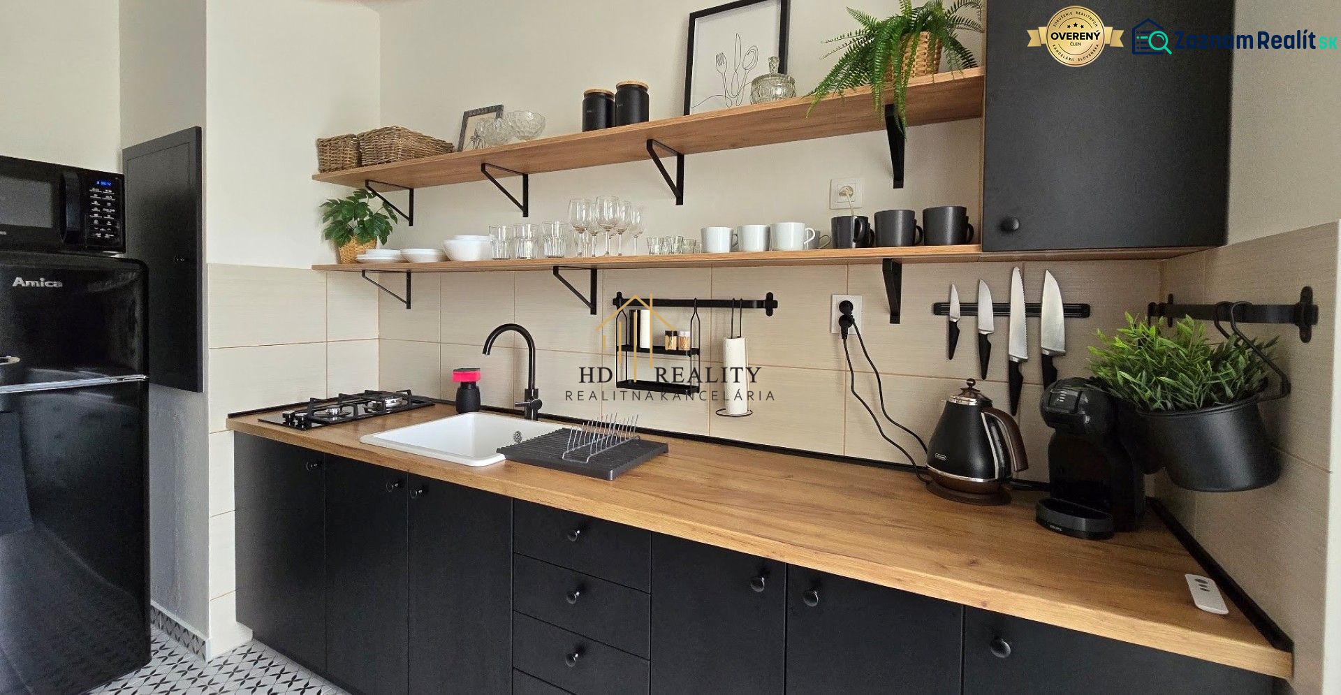 A kitchen in a 3-room apartment with shelves, dishes, and appliances, with a floor featuring a wooden decor.
