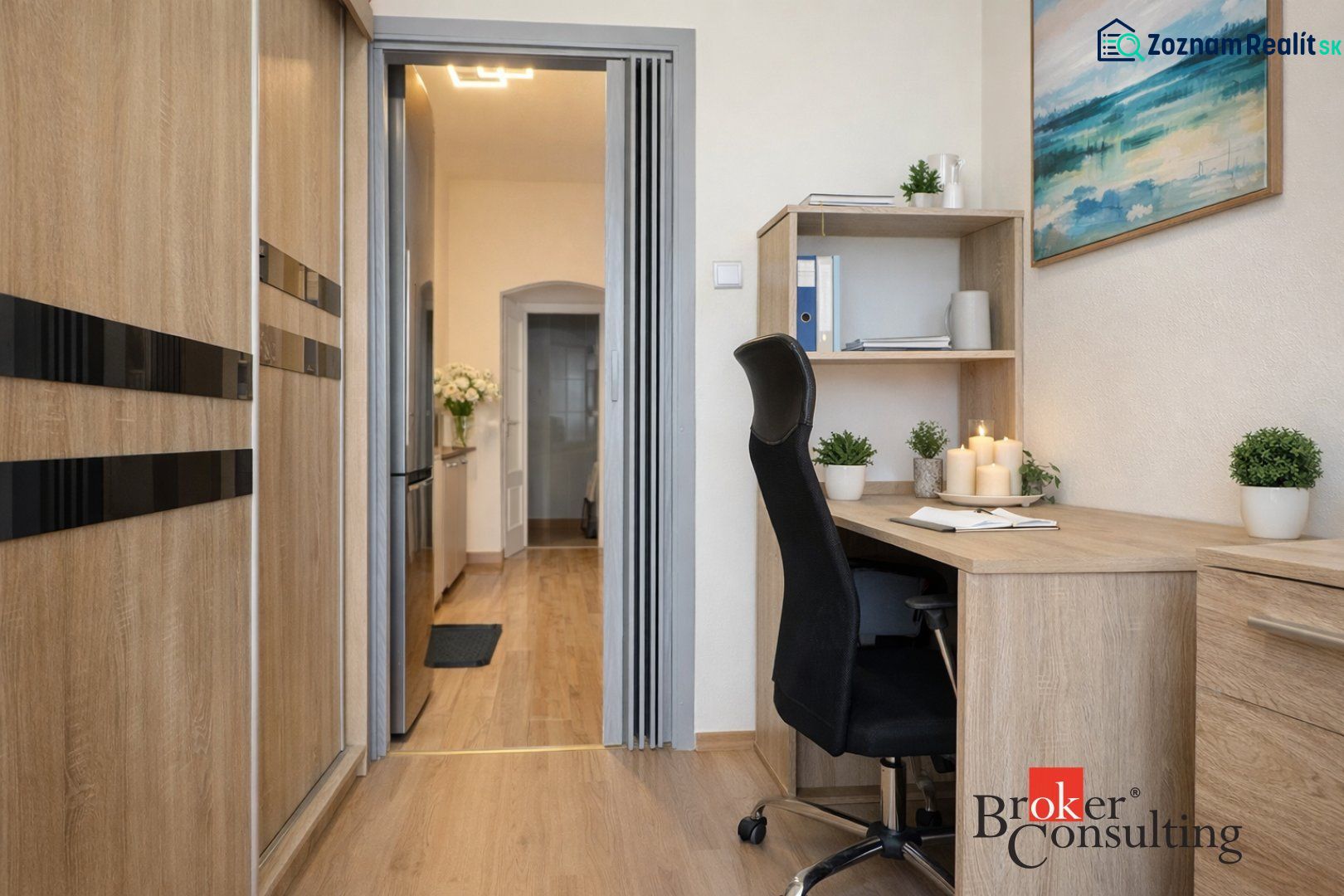 A workspace in a 3-room apartment with a wooden decor floor and office furniture.