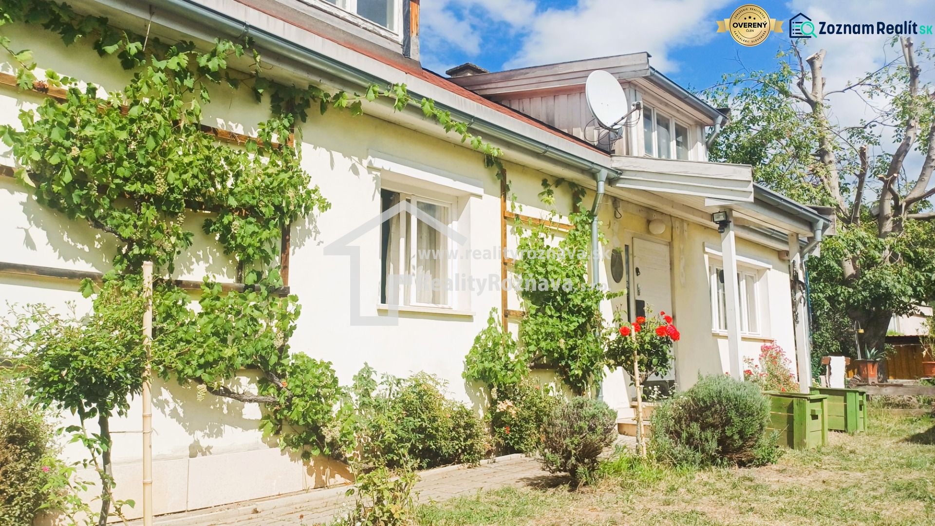 A family house in Rožňava with climbing plants and a two-story roof.