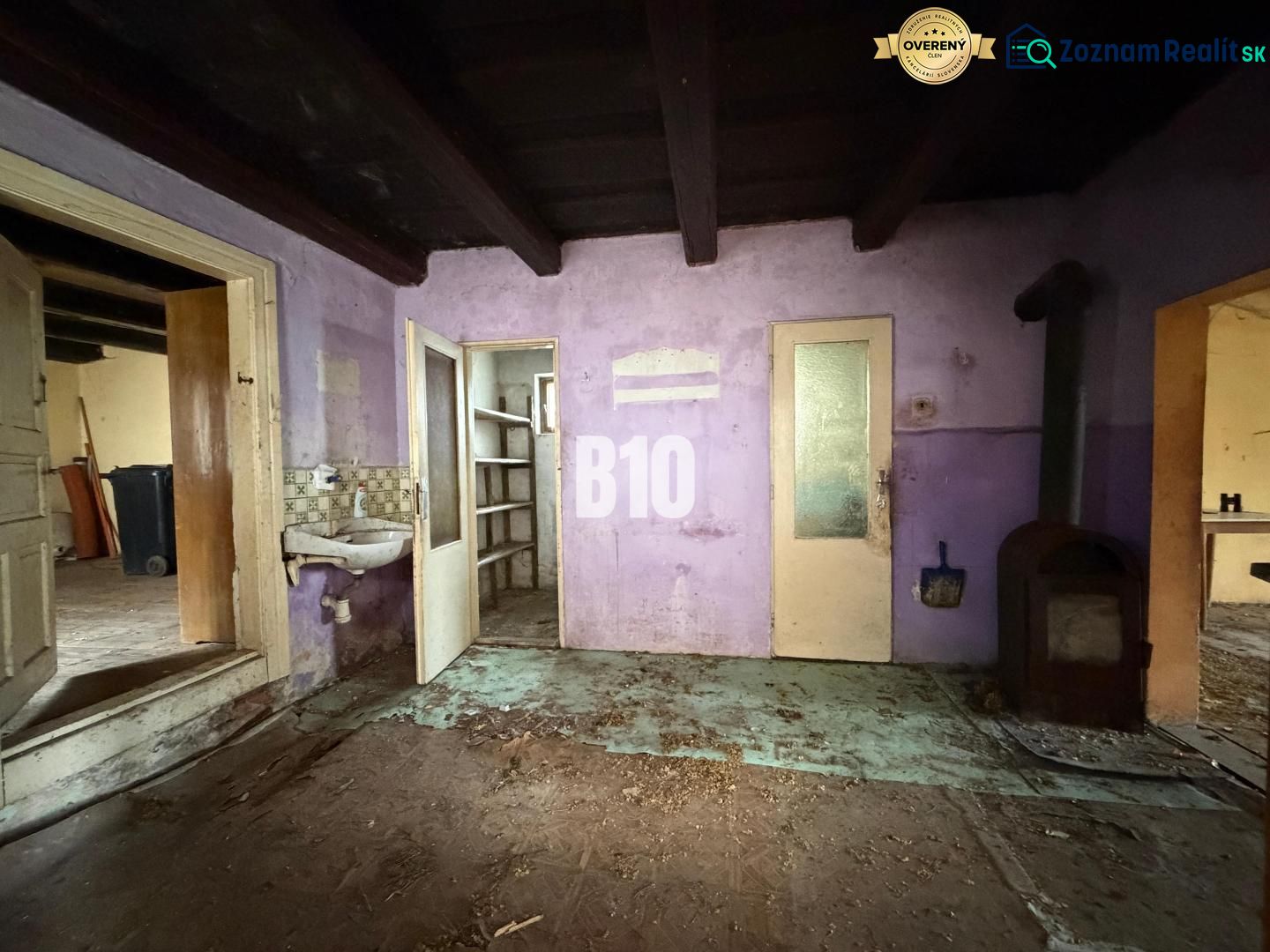 Purple walls, stove, and sink in the interior of a family house.