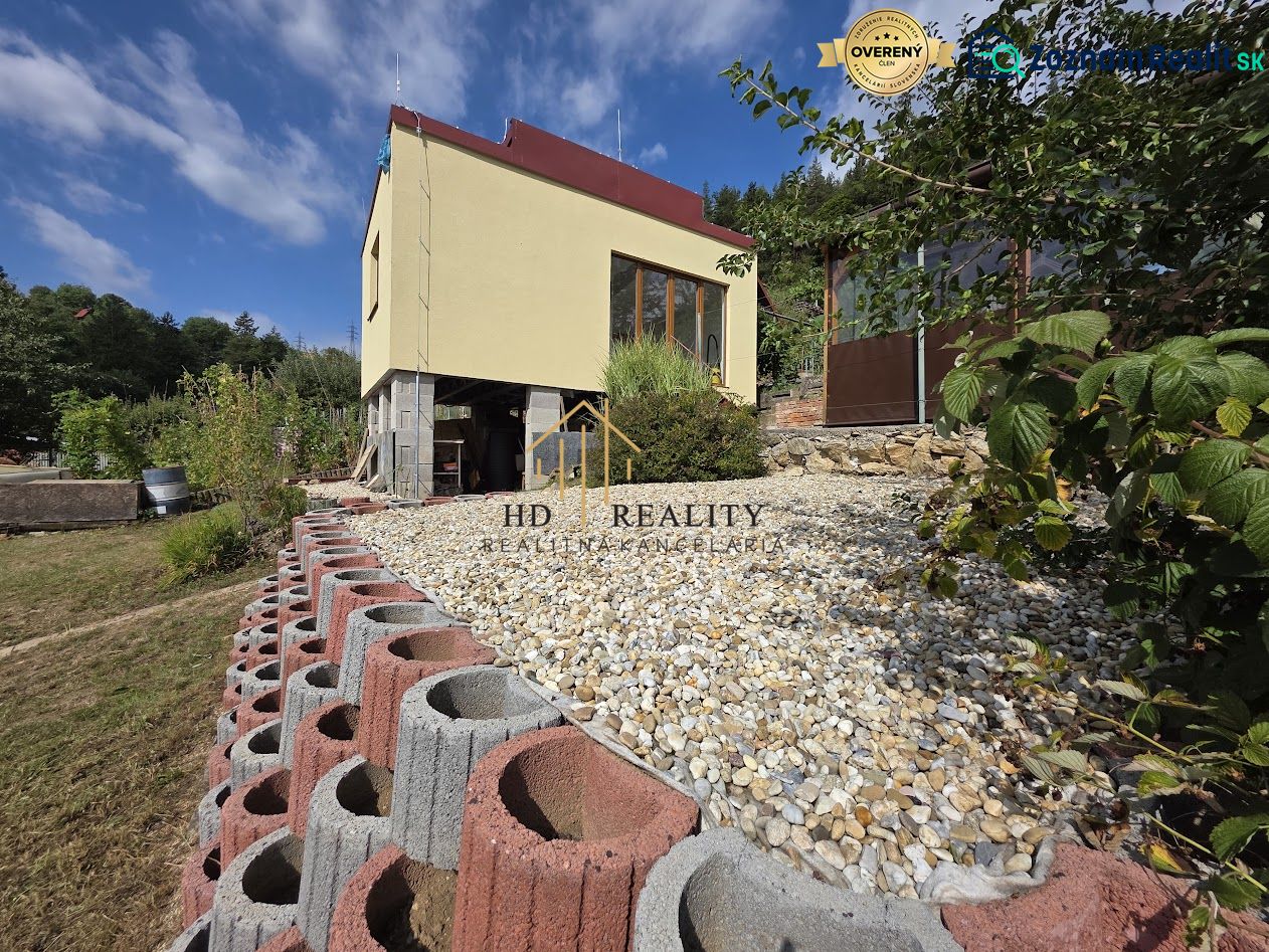 A cottage on Tulská Street in Banská Bystrica with an elevated garden and stone landscaping.