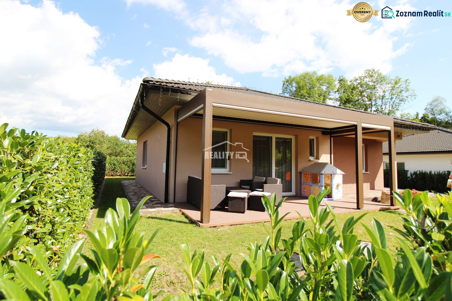 A family house in Bytča with a garden, terrace, and covered seating area in a sunny environment.