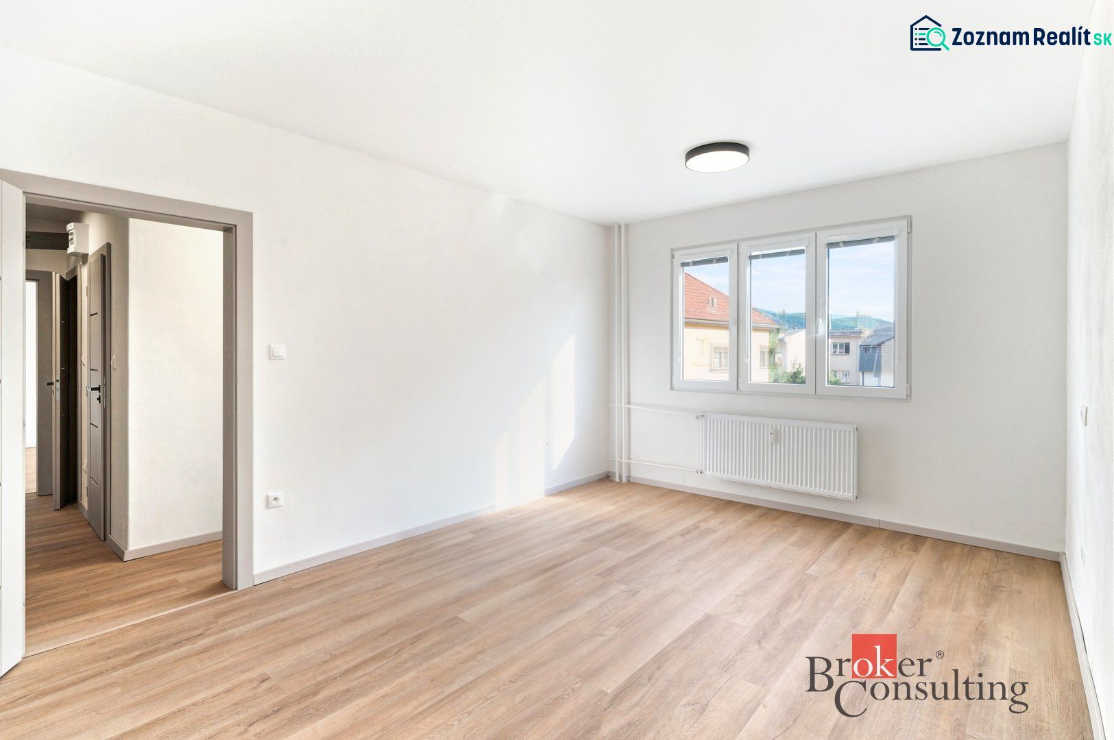 Hallway in a 2-room apartment with coat racks and a wooden-patterned floor.