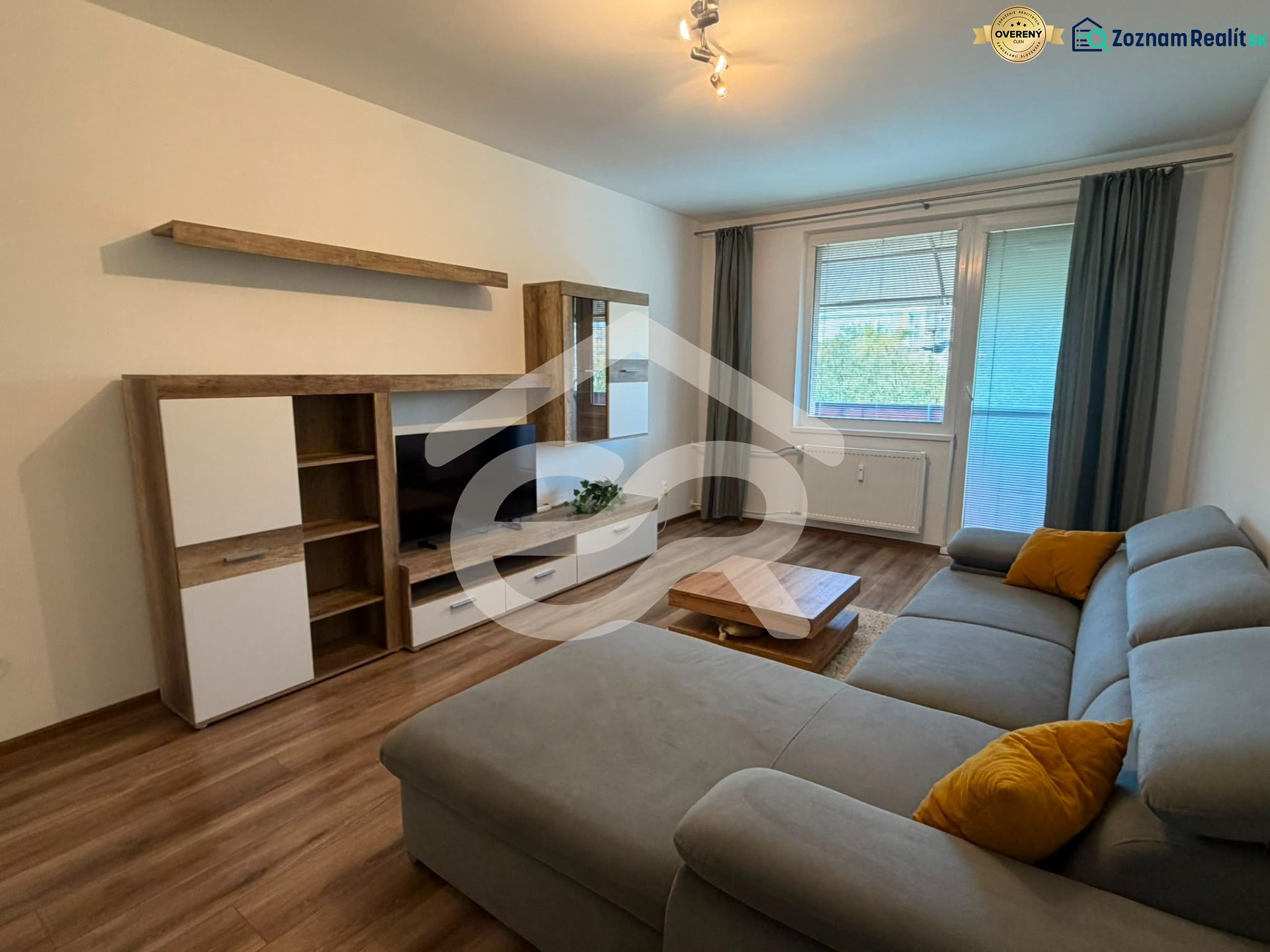 Living room in a two-room apartment with a comfortable sofa and a wooden decor floor.