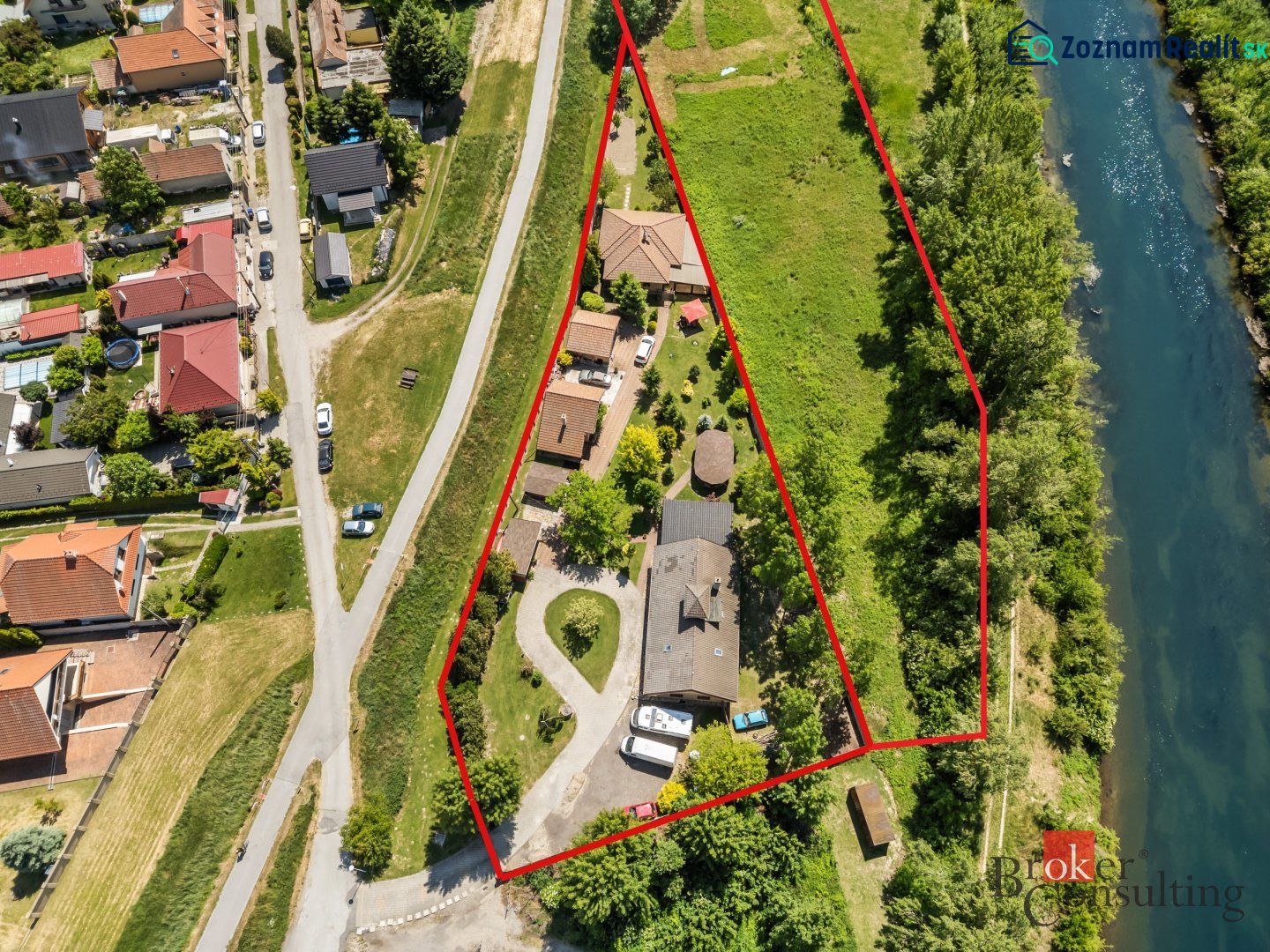 Aerial view of a family house in Hamuliakovo by the river with the plot marked.