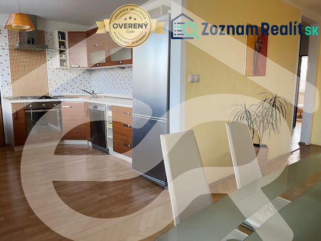 A kitchen with a wood-patterned floor in a 3-room apartment, modern furniture and decorations.