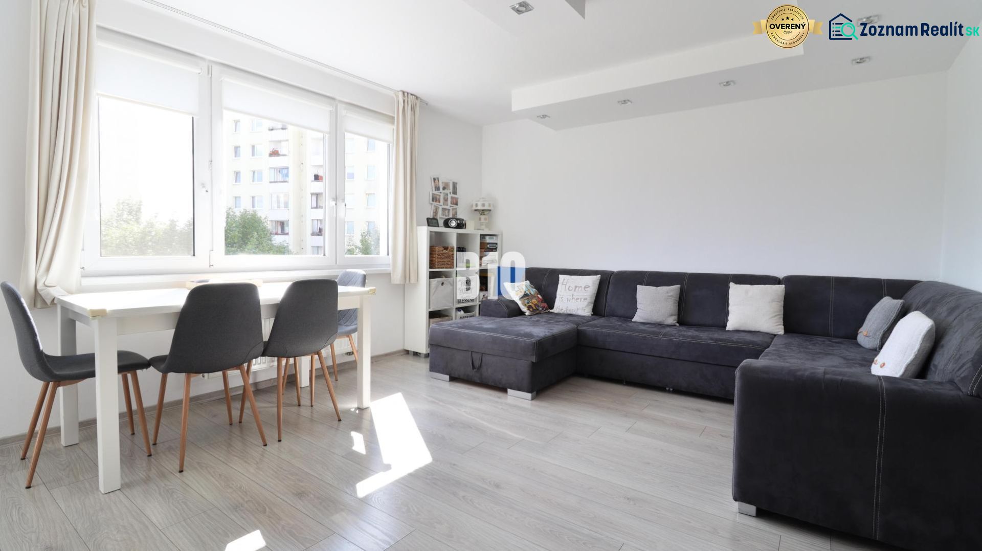 Living room, gray sofa, dining table, wooden decor flooring, 3-room apartment.