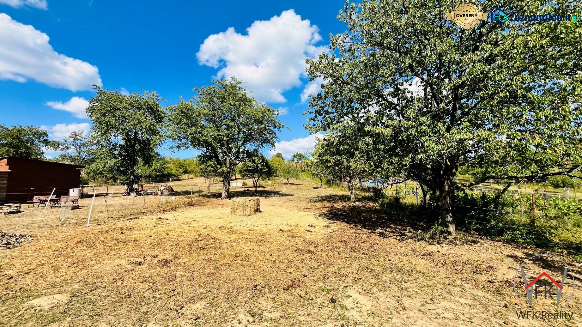 A plot of land by a family house in Ondavské Matiašovce with grass and trees in the countryside.