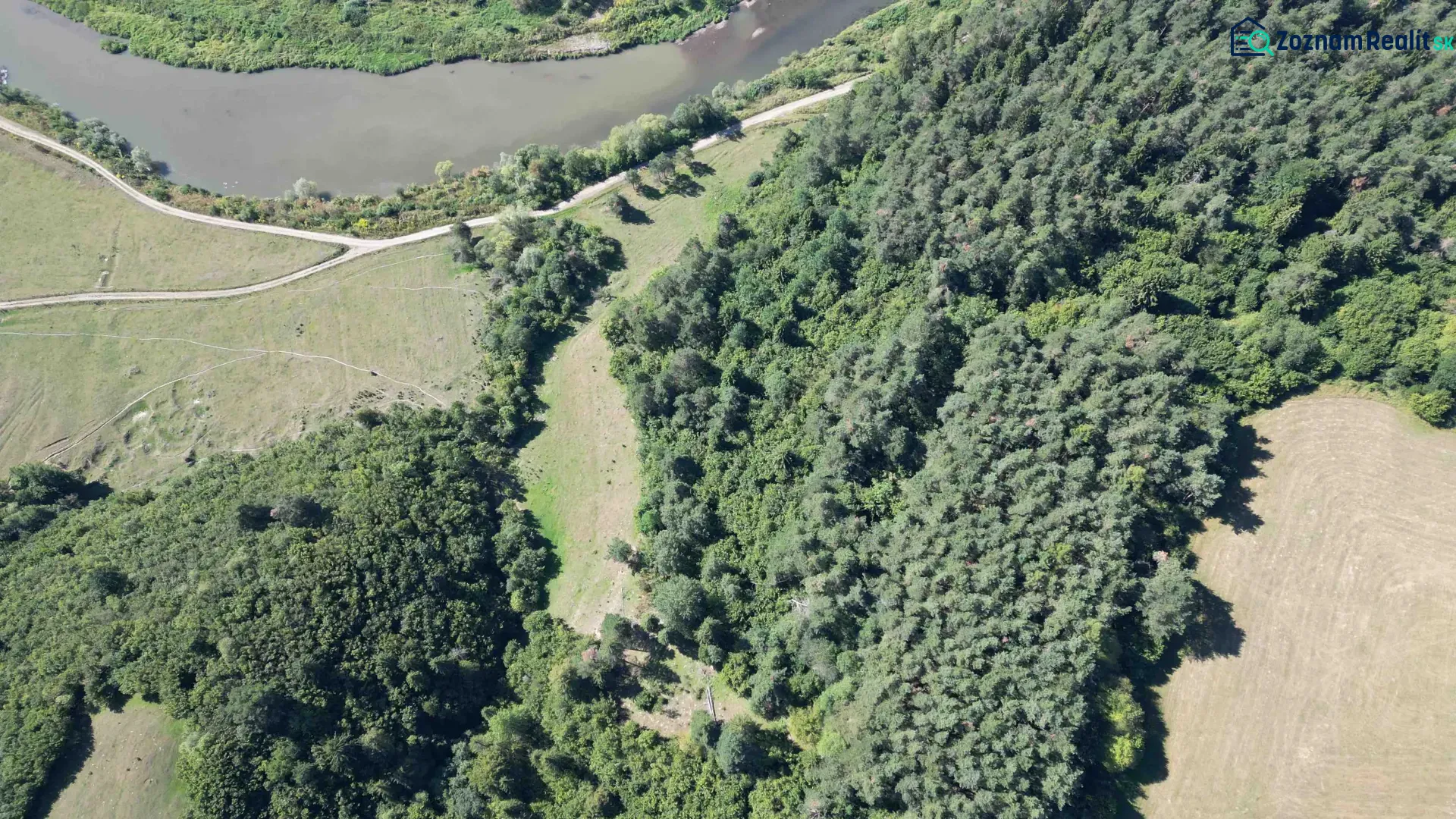 A river and roads surrounded by forests and fields in Plaveč on agricultural and forest land.
