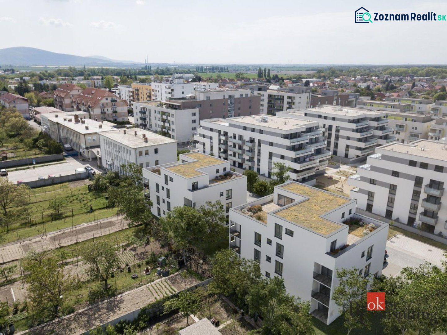 A view of apartment buildings on Cementárenská Street in Stupava with plenty of greenery.