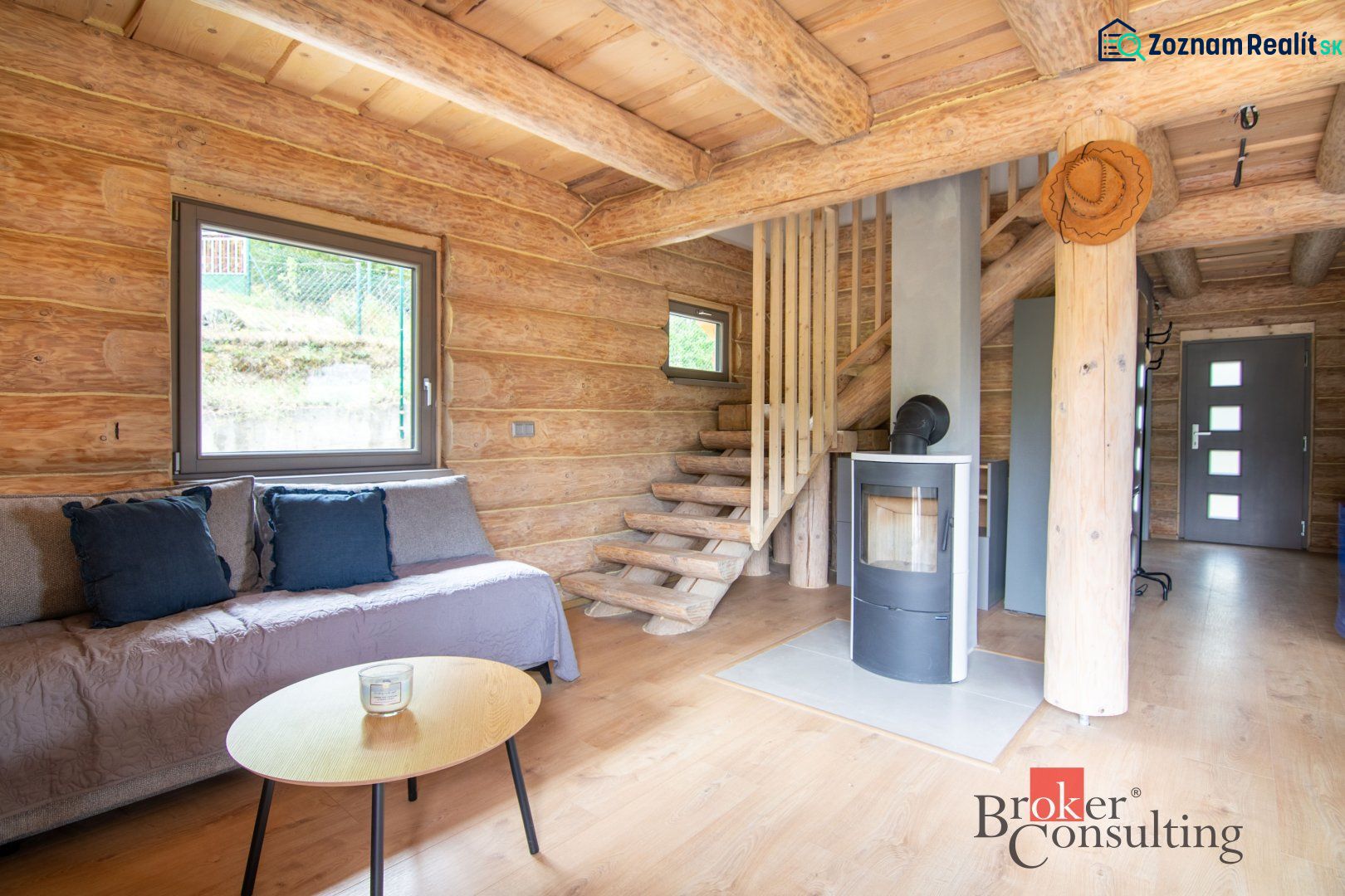 Interior of a family house with a wooden decor floor and a fireplace, solid wood stairs.