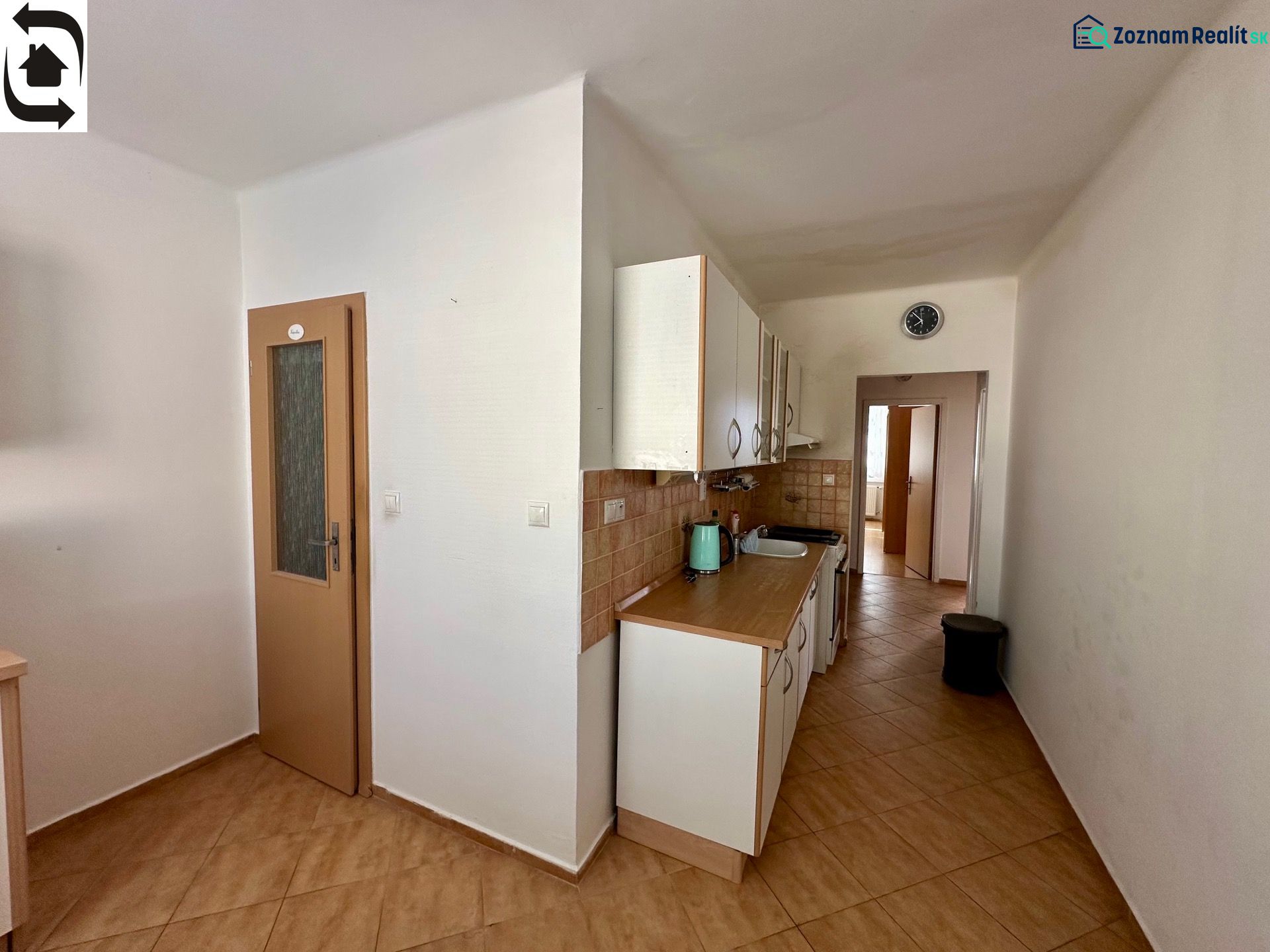 A kitchen in a 4-room apartment with a wooden decor floor and ceramic tiles.