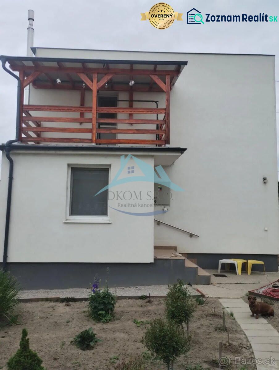 A family house in Bratislava with a balcony and a small garden in a simple style.