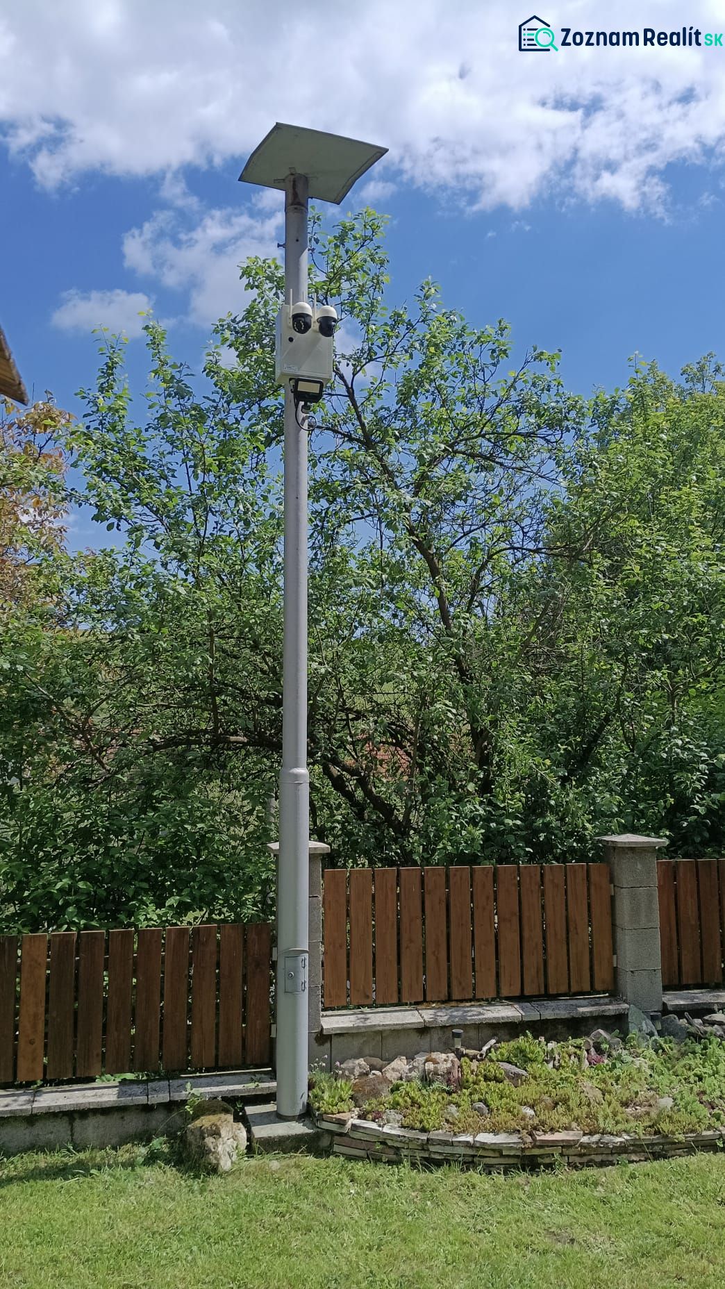 Solar lighting with a camera by the fence in the garden of a family house in Mikušovce.