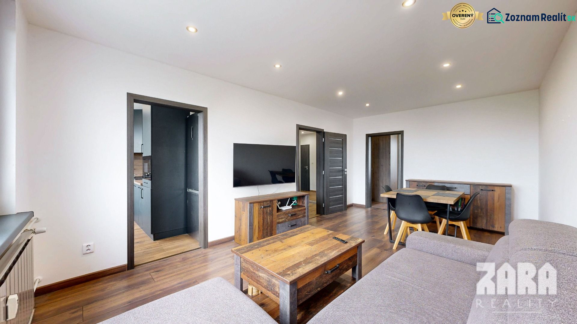 Living room with wood-patterned flooring and furniture in a 4-room apartment.