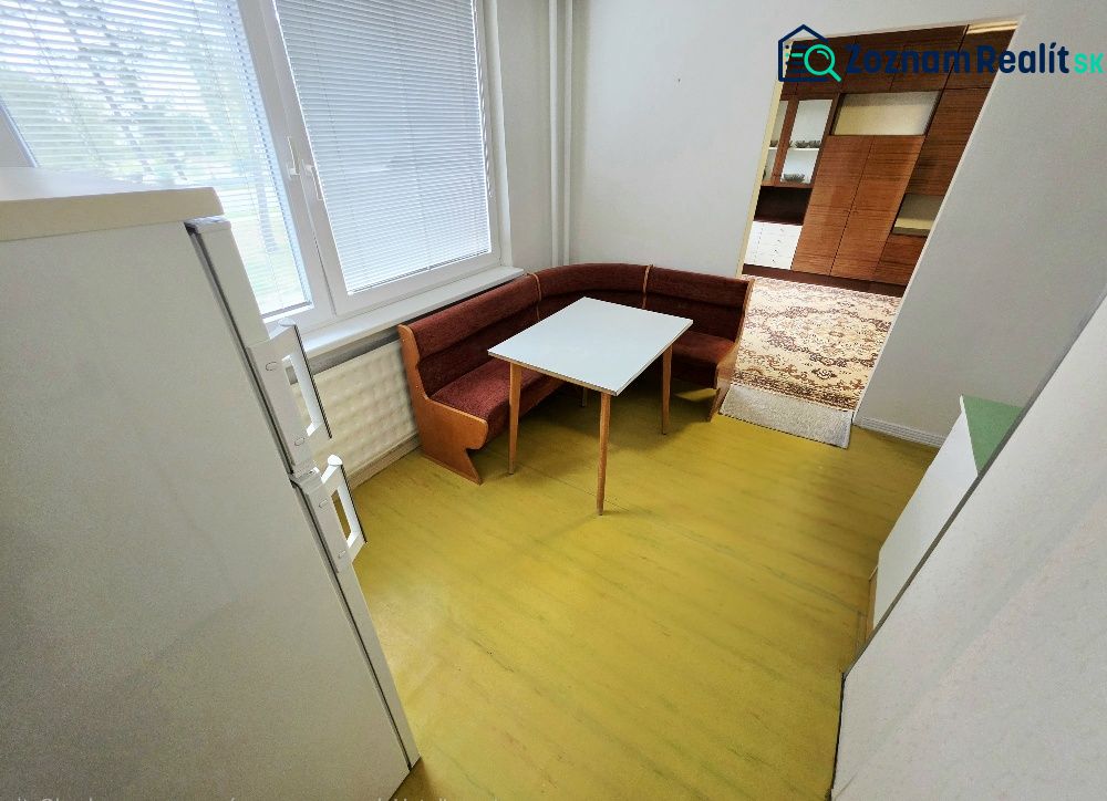 A kitchen in a 3-room apartment with a corner bench and table.
