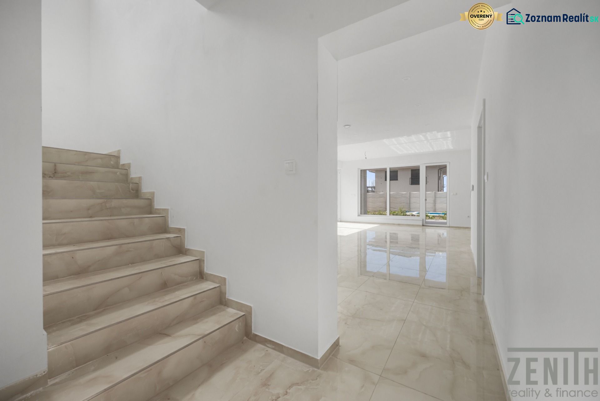 Stairs and a bright hallway in a family house, floor with wooden decor.