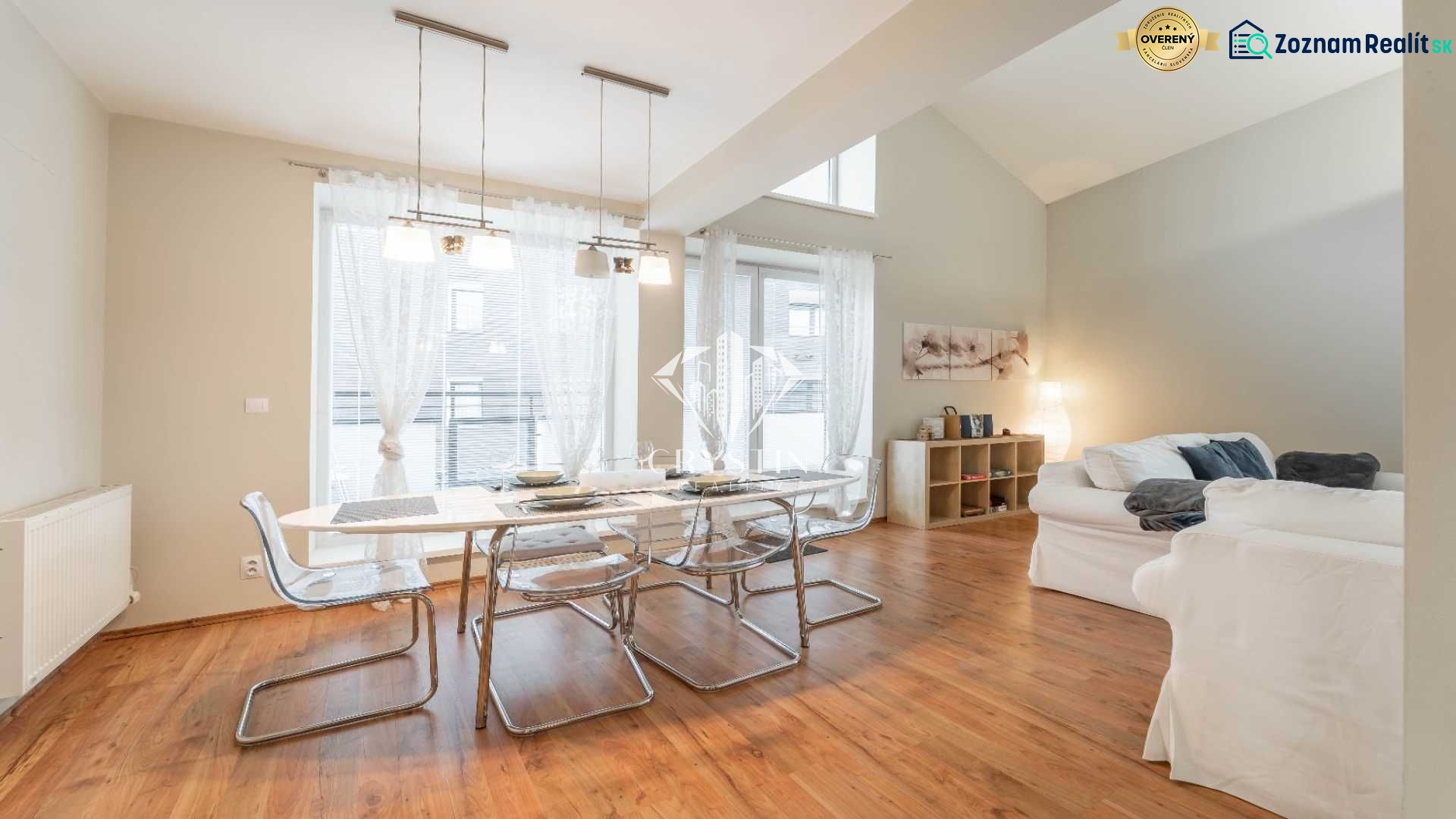 Recreational apartment with a dining table, comfortable sofas, and a wooden decor floor.