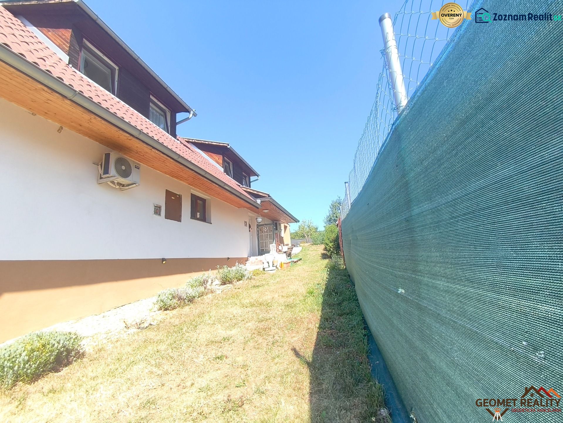 A family house in Divín with air conditioning, fencing, and a garden with a lawn.