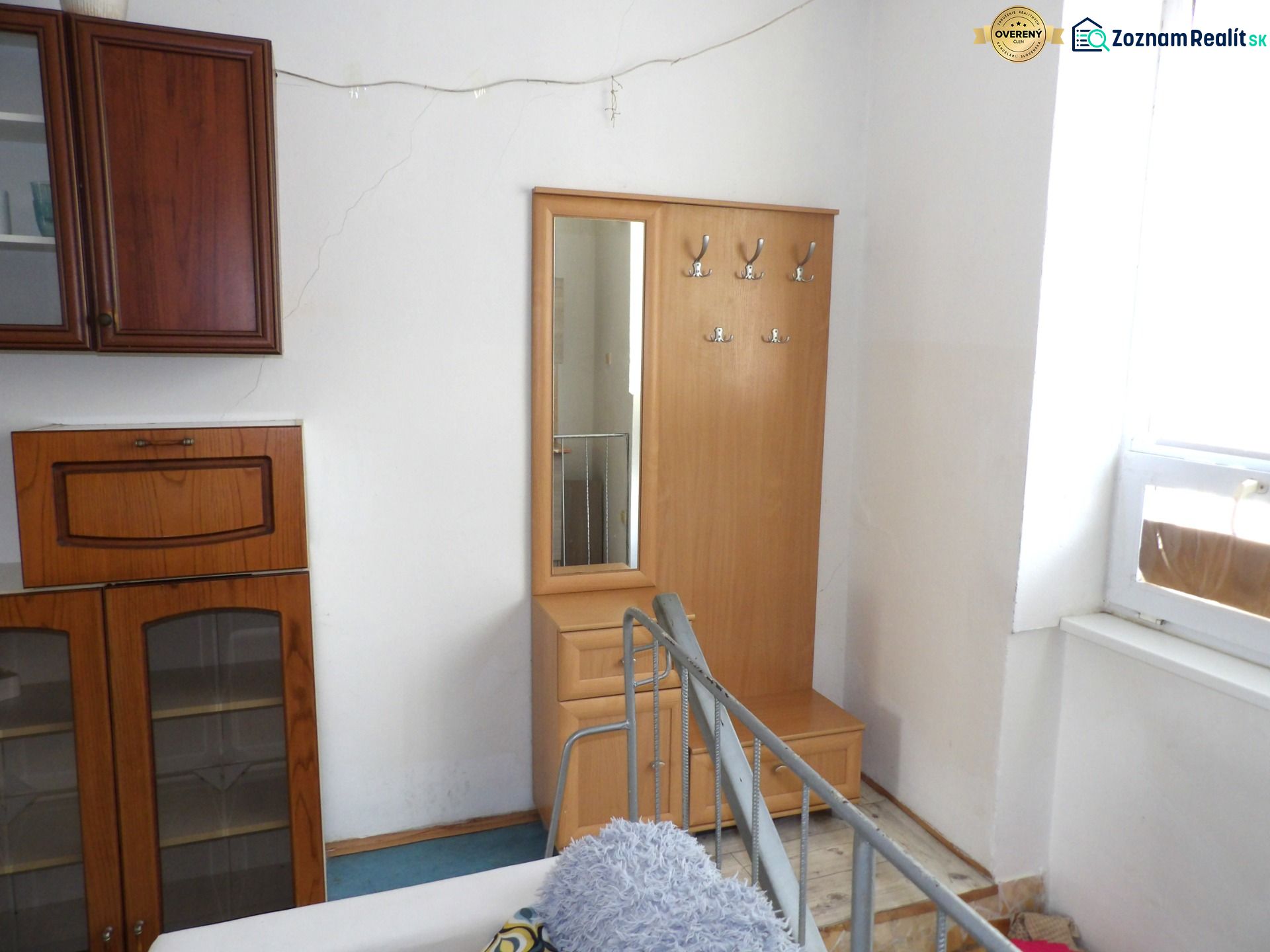 In a 2-room apartment, there is a coat rack with a mirror and a storage cabinet.