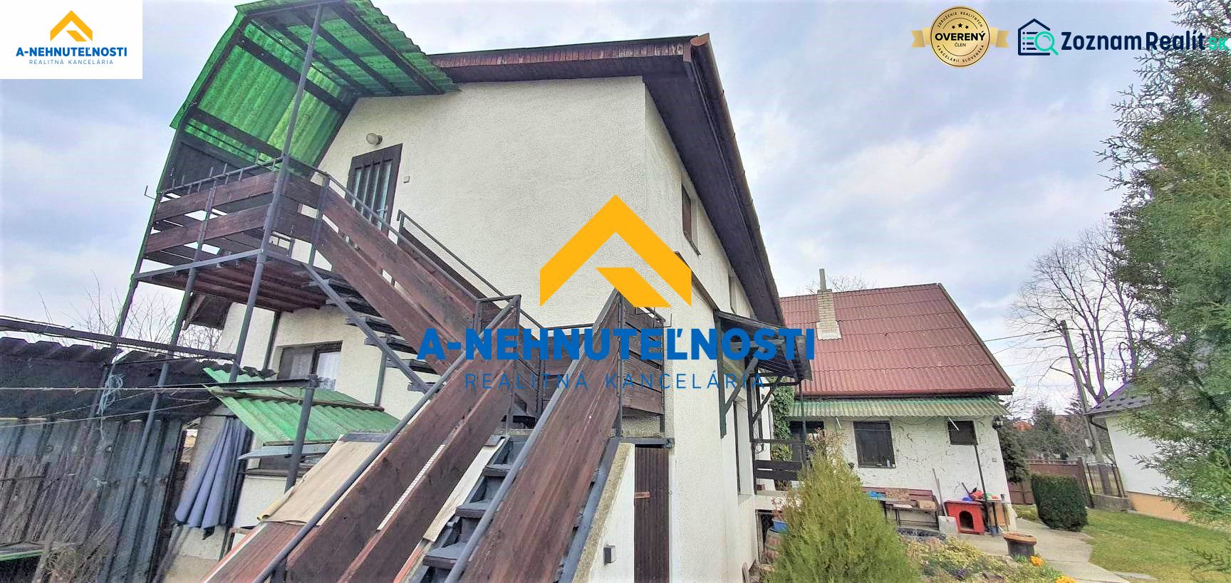 A family house in Veľký Meder with an external staircase and wooden railing.
