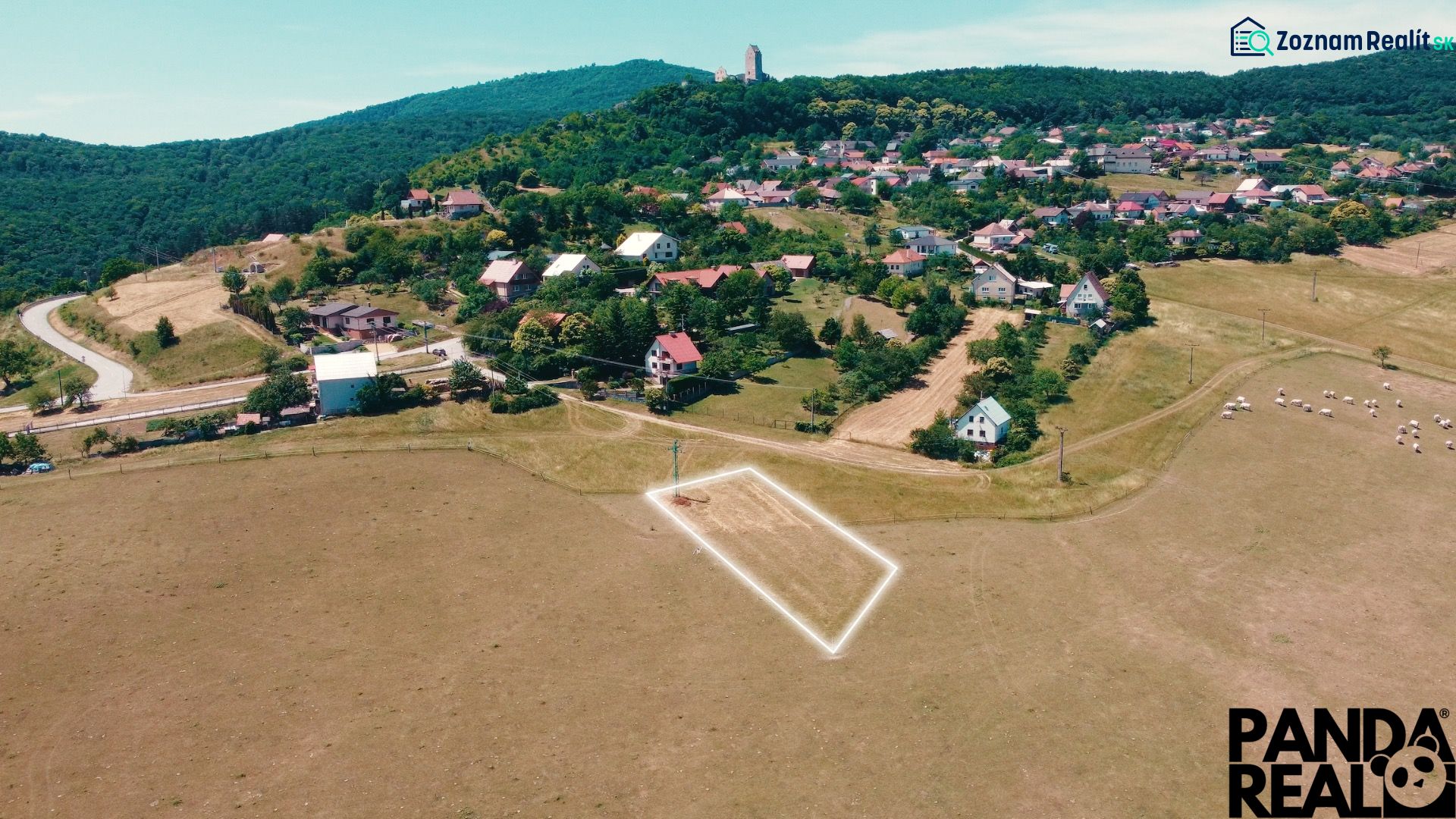 Picturesque landscape of Podhradie, residential plots nestled in green hills.