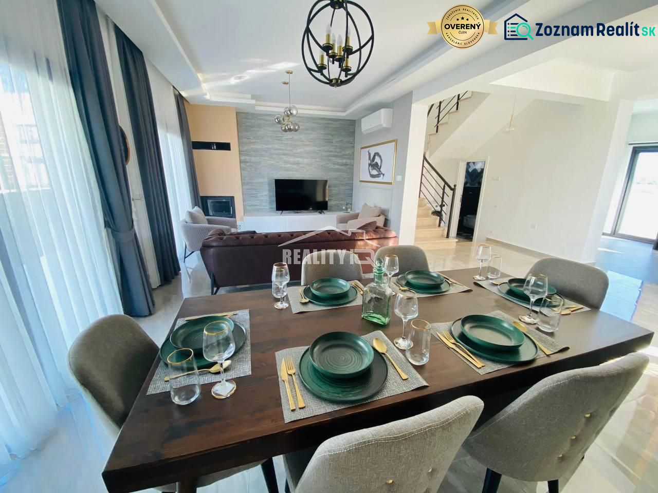 A dining room in a family house with elegant dark furnishings and six chairs.