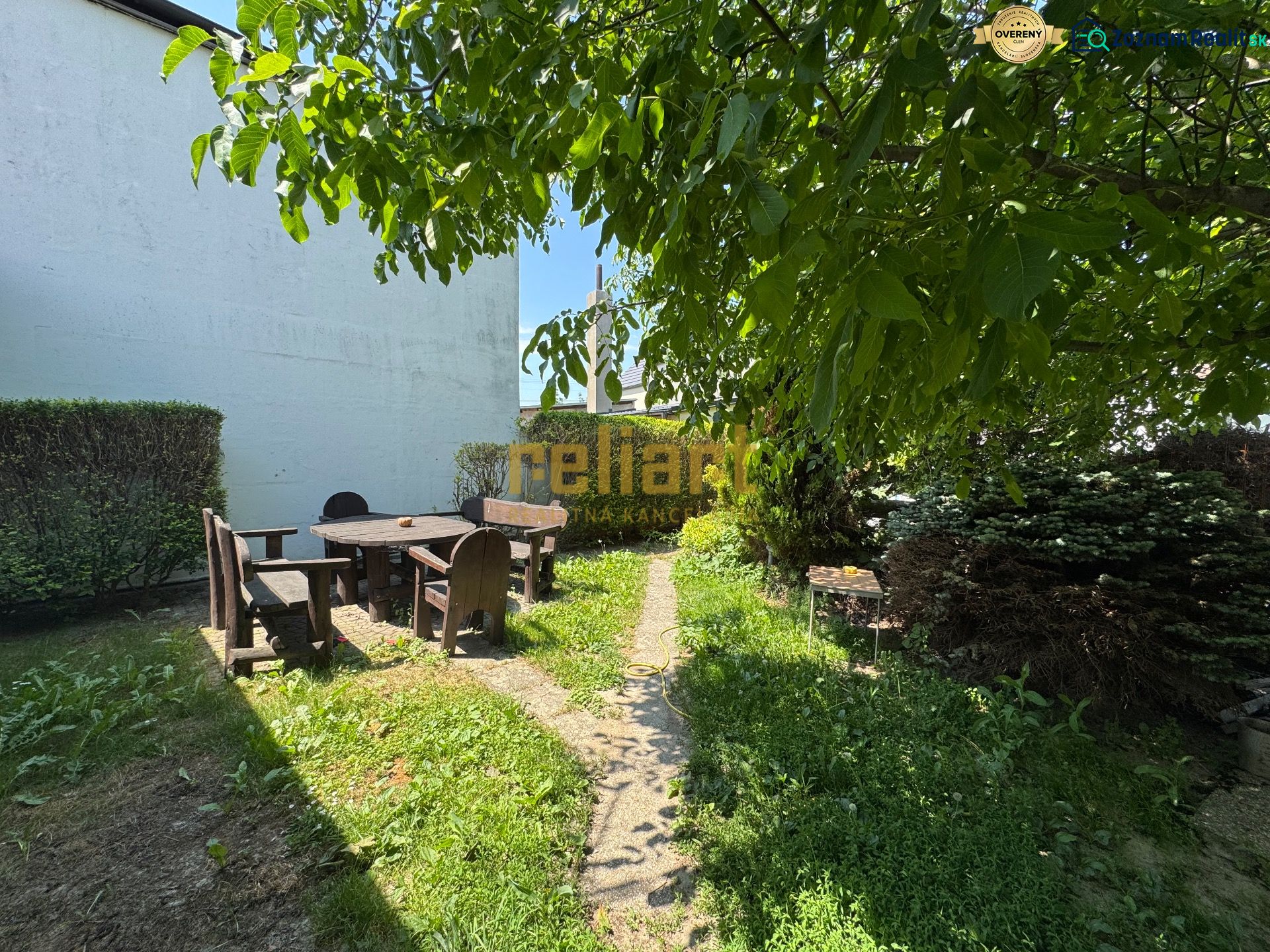 The garden of a family house on Senná Street in Bratislava - Ružinov, with seating in pleasant shade.