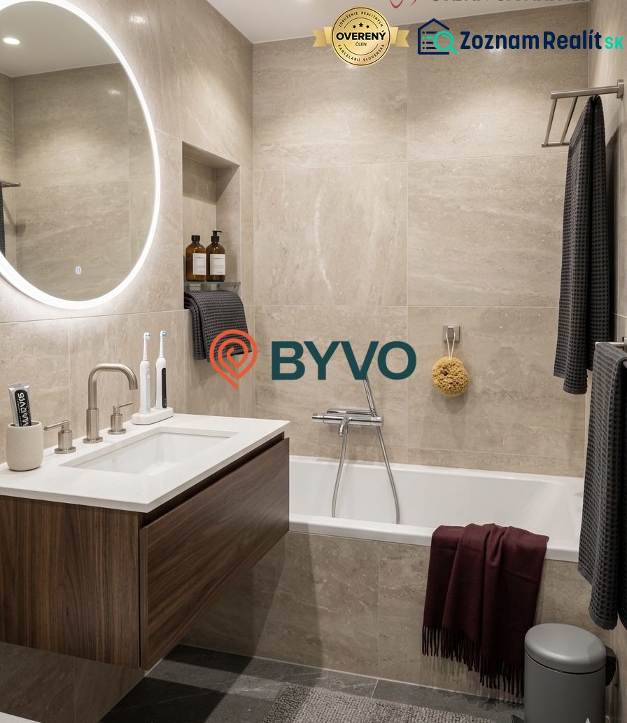 Bathroom with a bathtub, wall-mounted sink, and round illuminated mirror in a 2-room apartment.