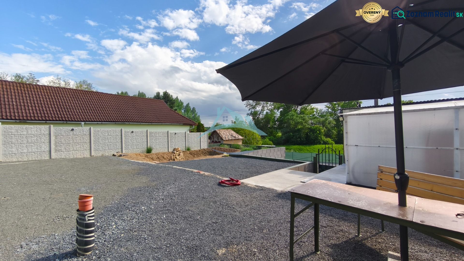 A courtyard with a stone surface and a large sunshade at the Recreational Grounds in Záhorce, Selešťany.