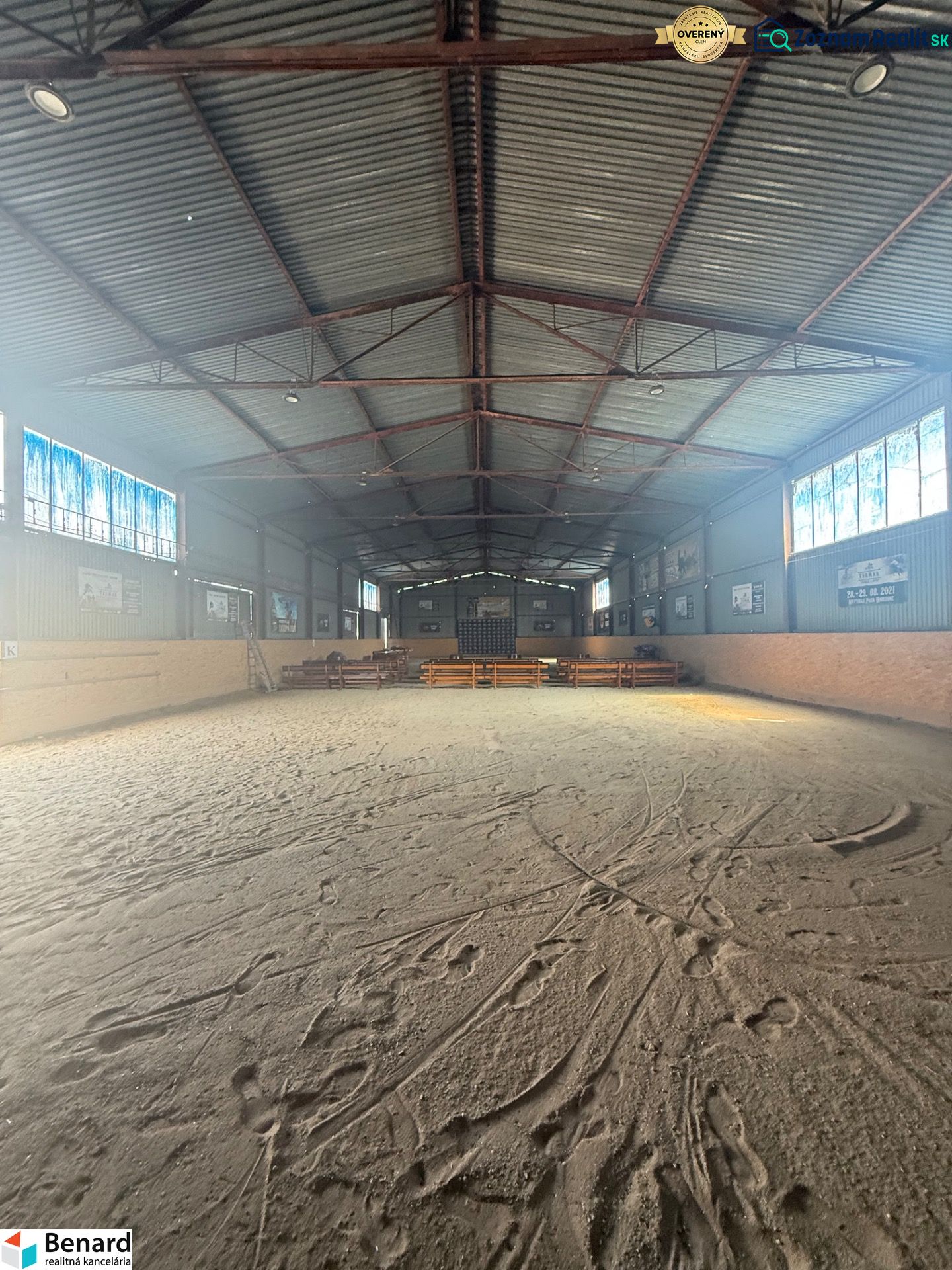 The interior of a building with a large spacious playground and a metal roof.
