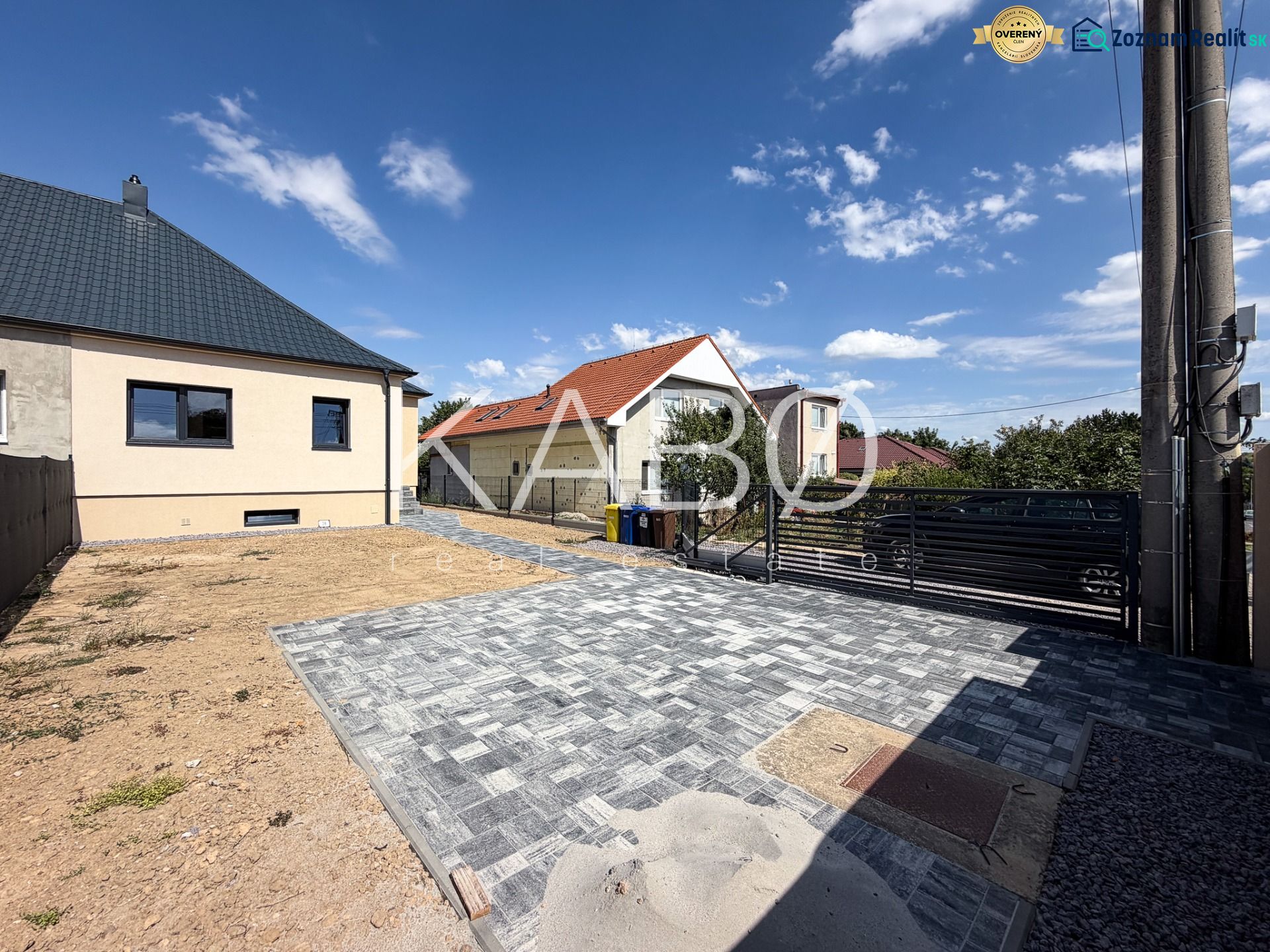 A family house on Trnavská Street in Nitra with a paved courtyard and blue sky.