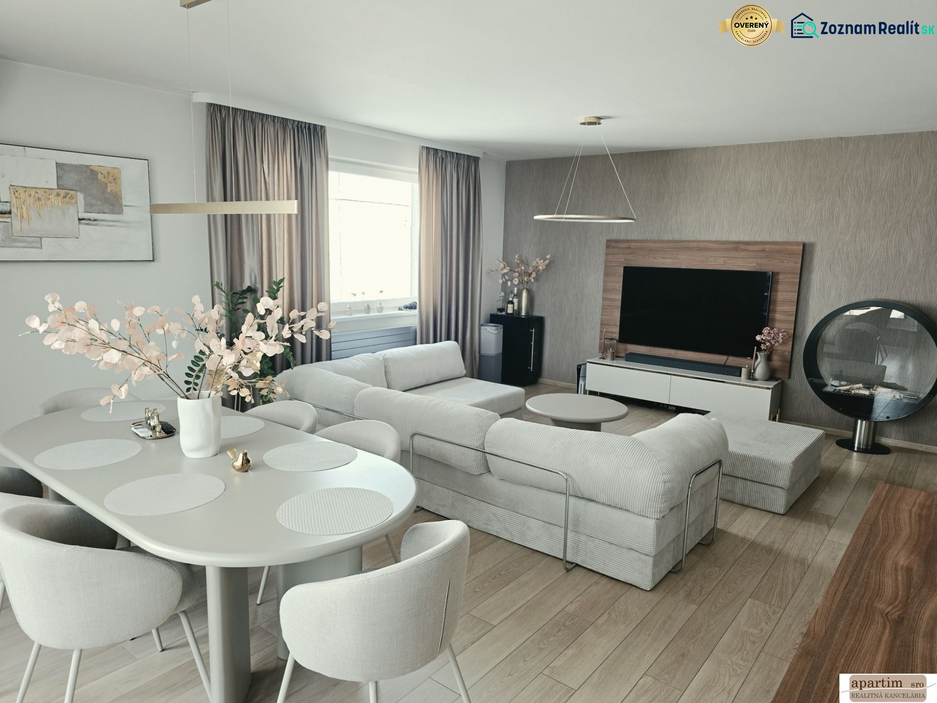 A stylish living room with a comfortable sofa, dining table, and wooden decor flooring in a 4-room apartment.