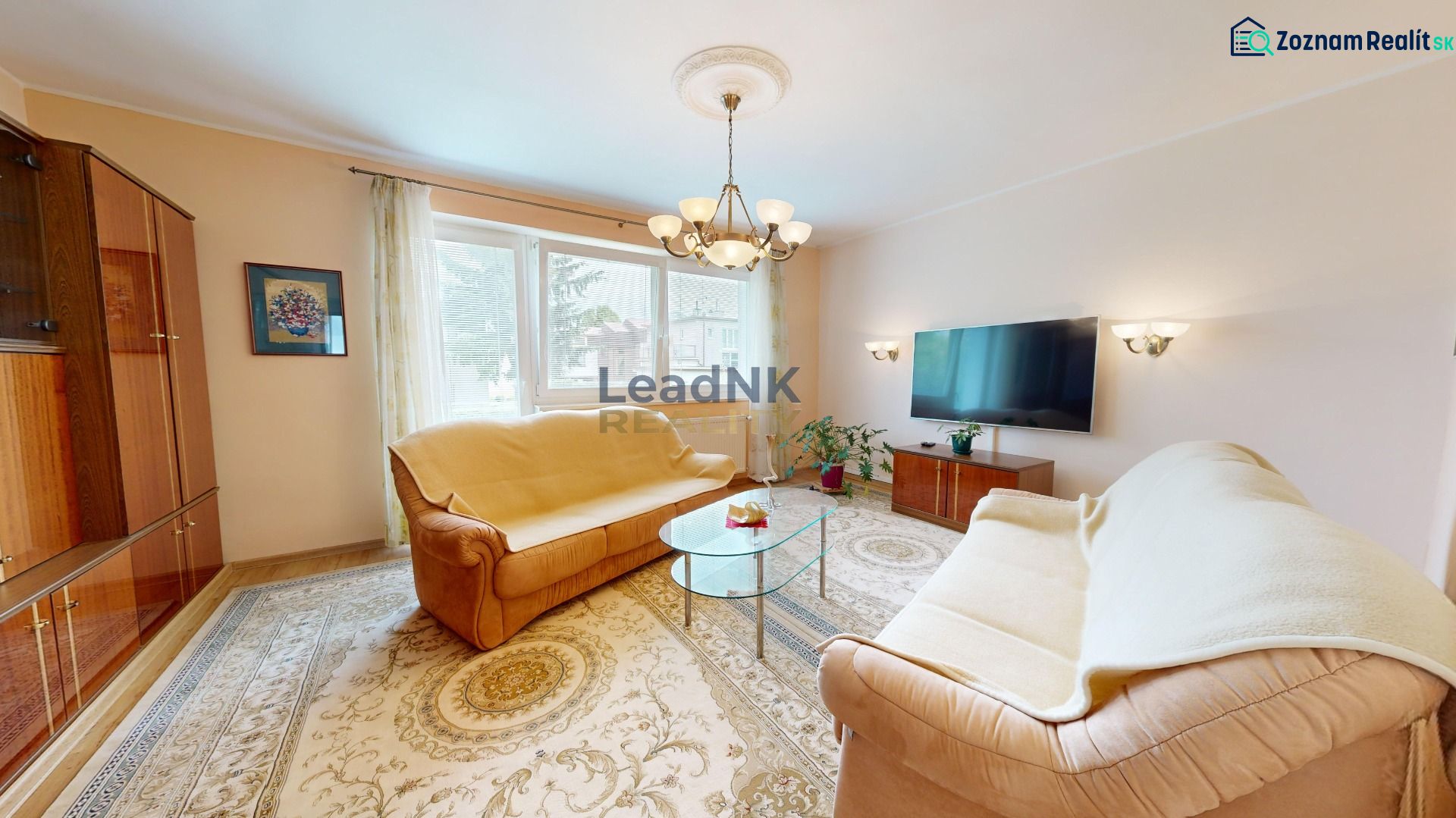 Living room with carpets, sofas, and a television in a 3-room apartment.