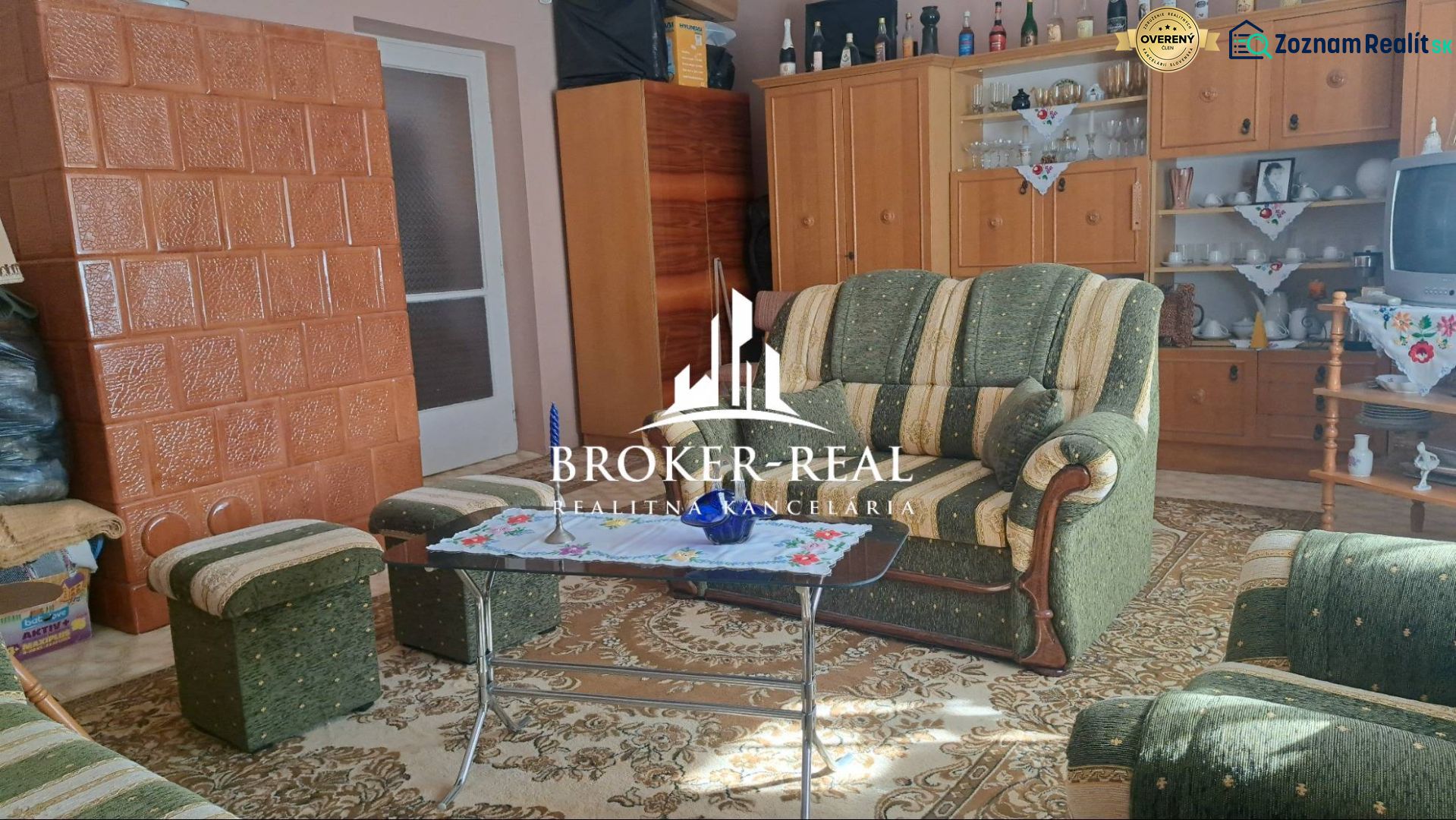 Interior of a family house with carpet decor, fireplace, and traditional furniture.