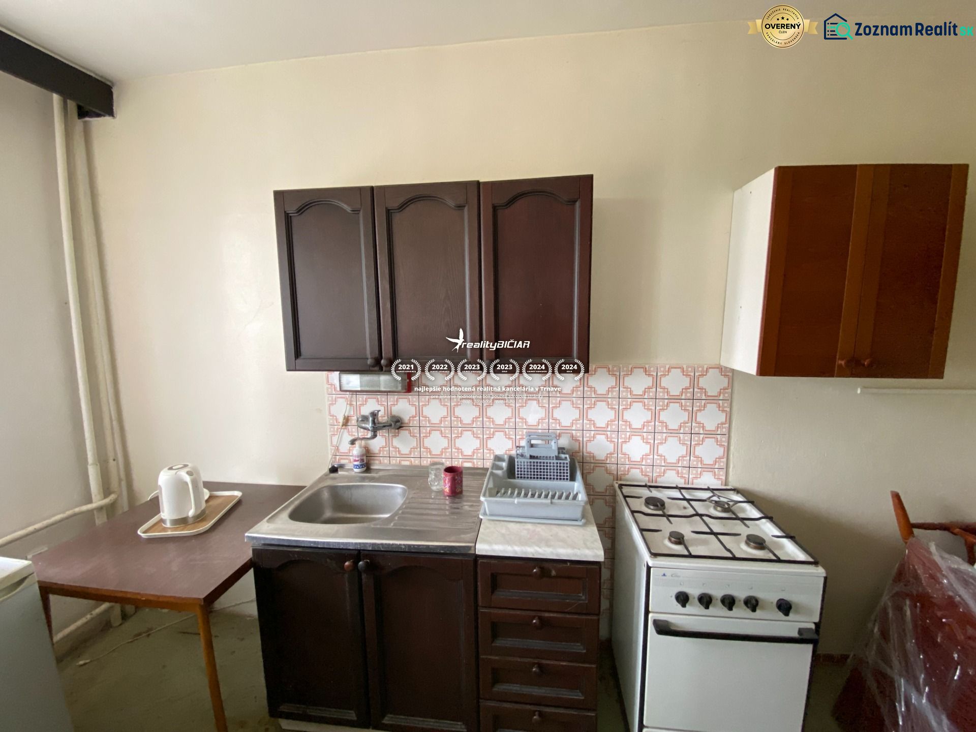Kitchen in a family house with a sink, stove, and cabinets.