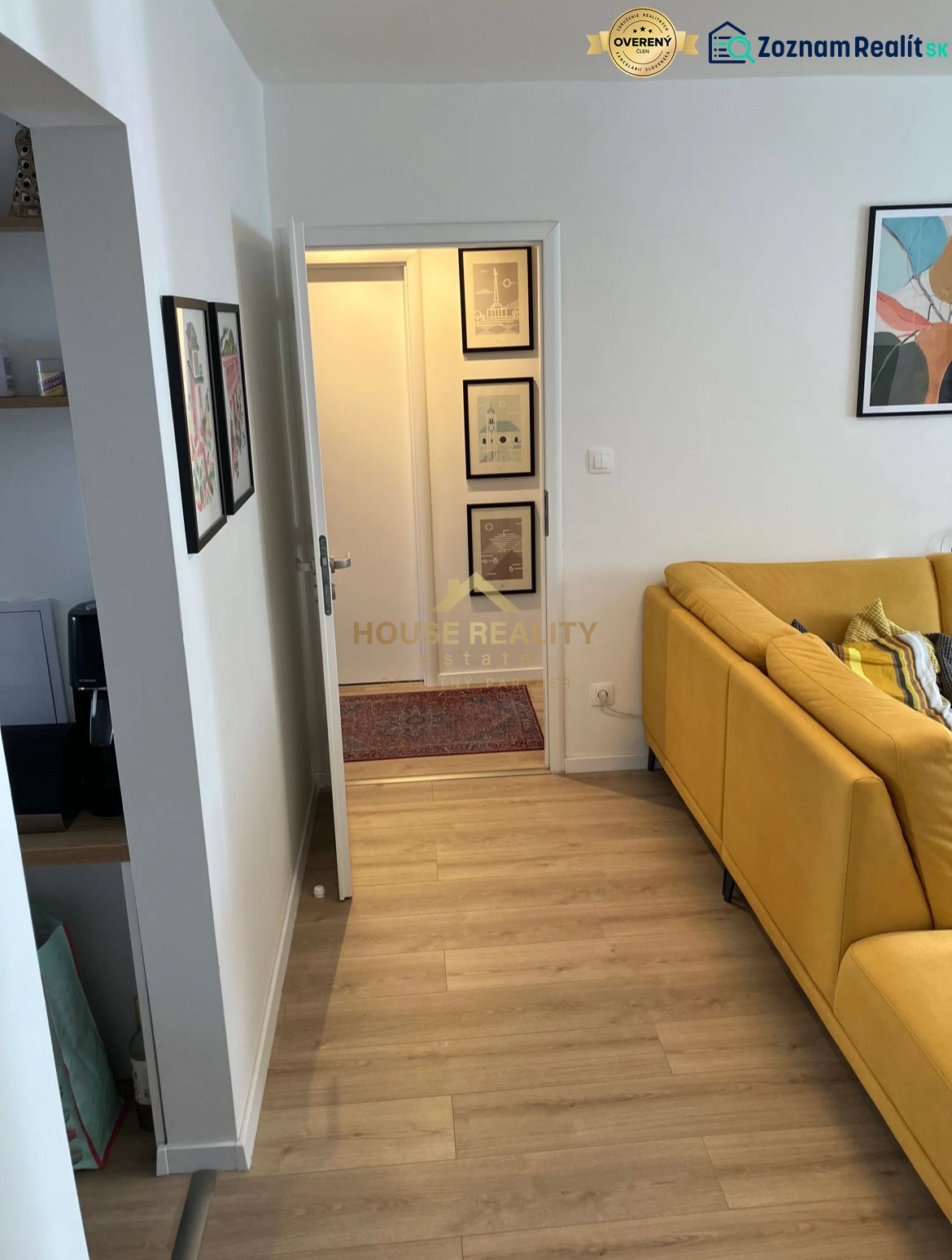 Light wood-effect flooring and a yellow sofa in a 3-room apartment.