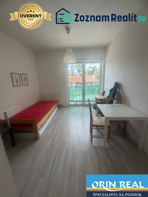Studio apartment with furniture, wooden decor flooring, bright space, and balcony doors.