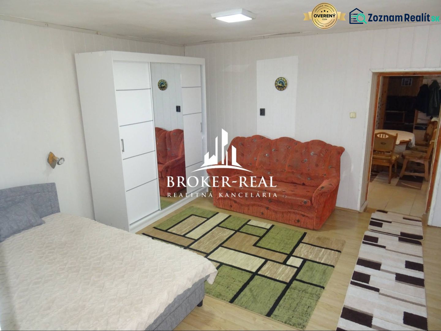 Family house with a bed, sofa, wardrobe, and floor with a wooden decor.