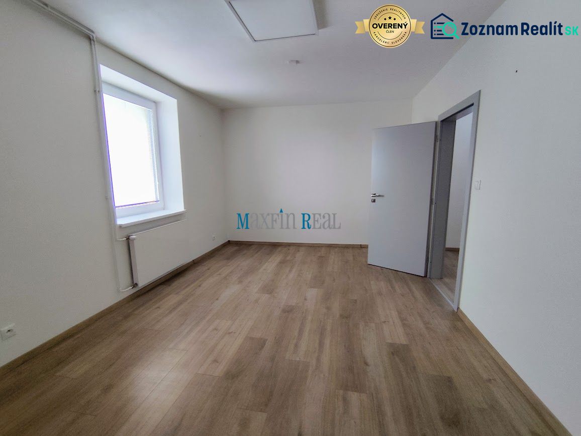 Offices with wood-patterned flooring and windows in a white interior.
