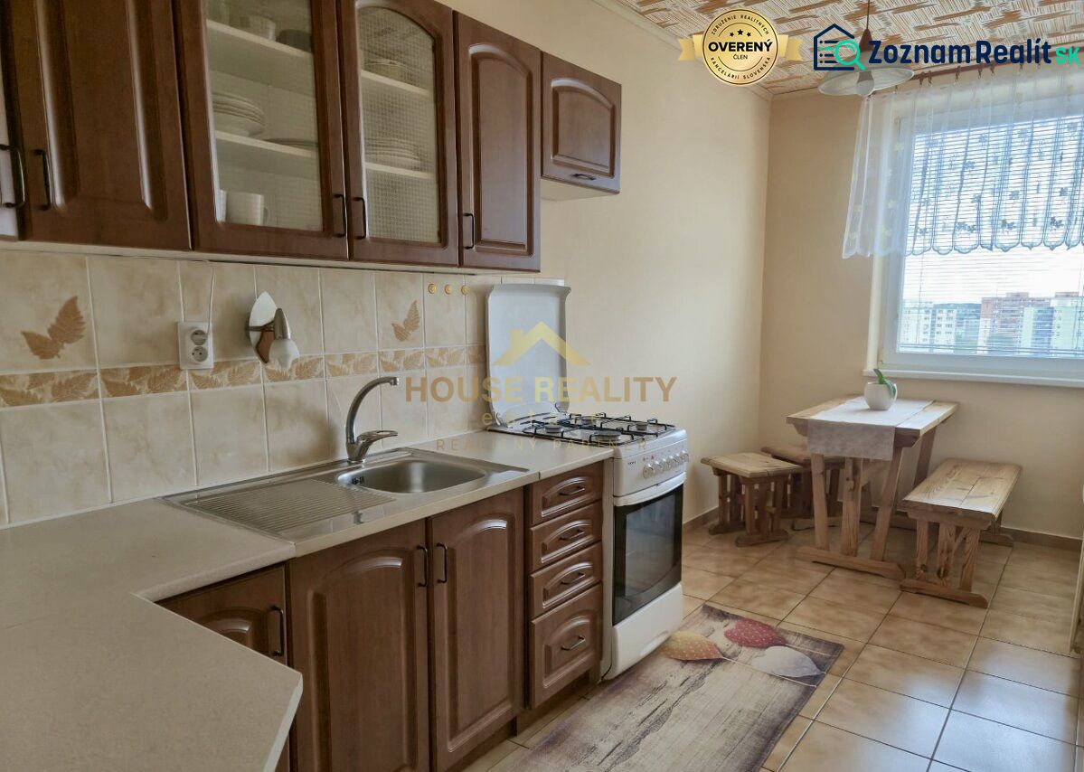 A kitchen in a 3-room apartment with a gas stove and a dining area.