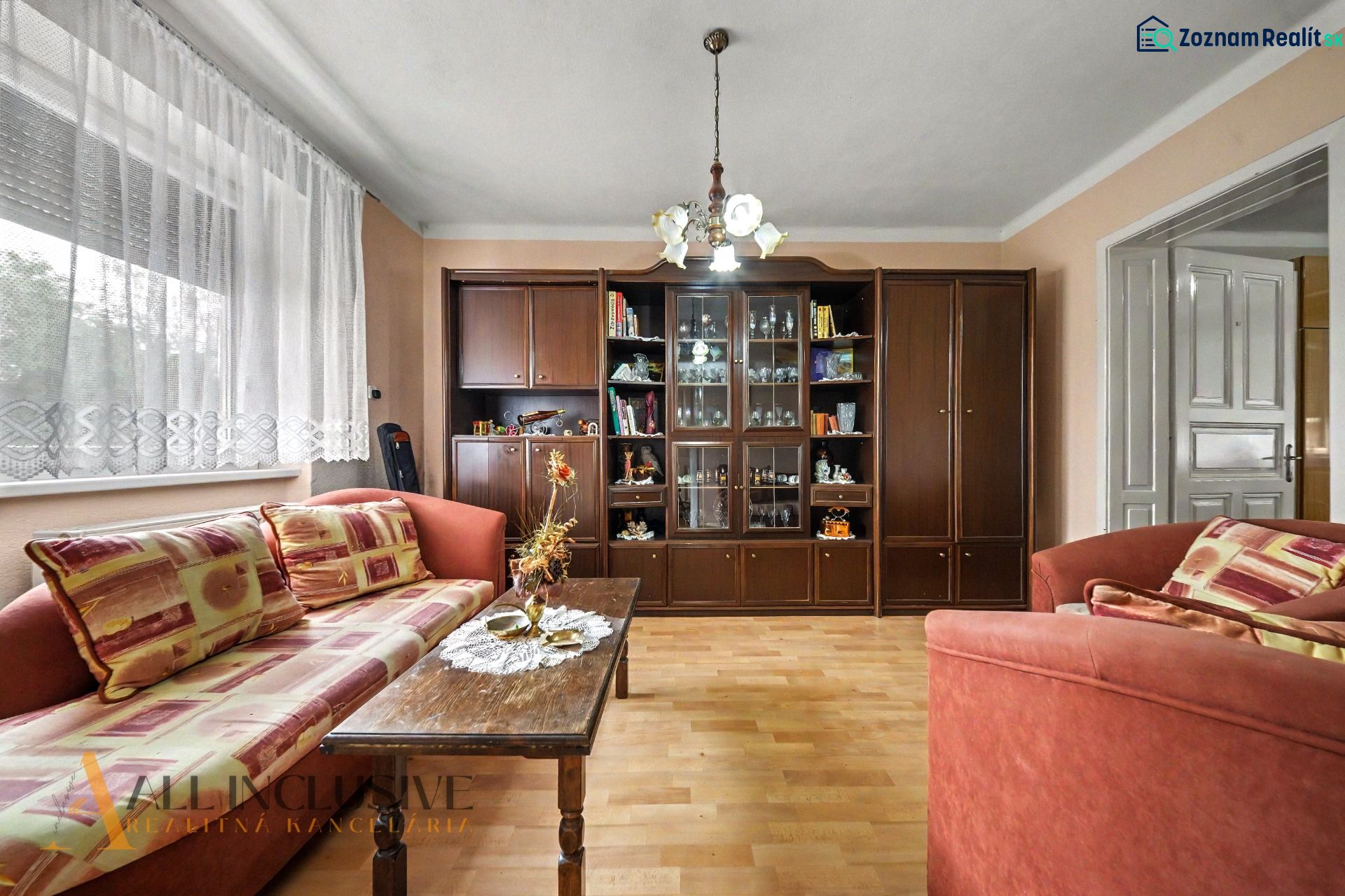 Living room in a family house with a wooden decor floor, furniture, and sofas.