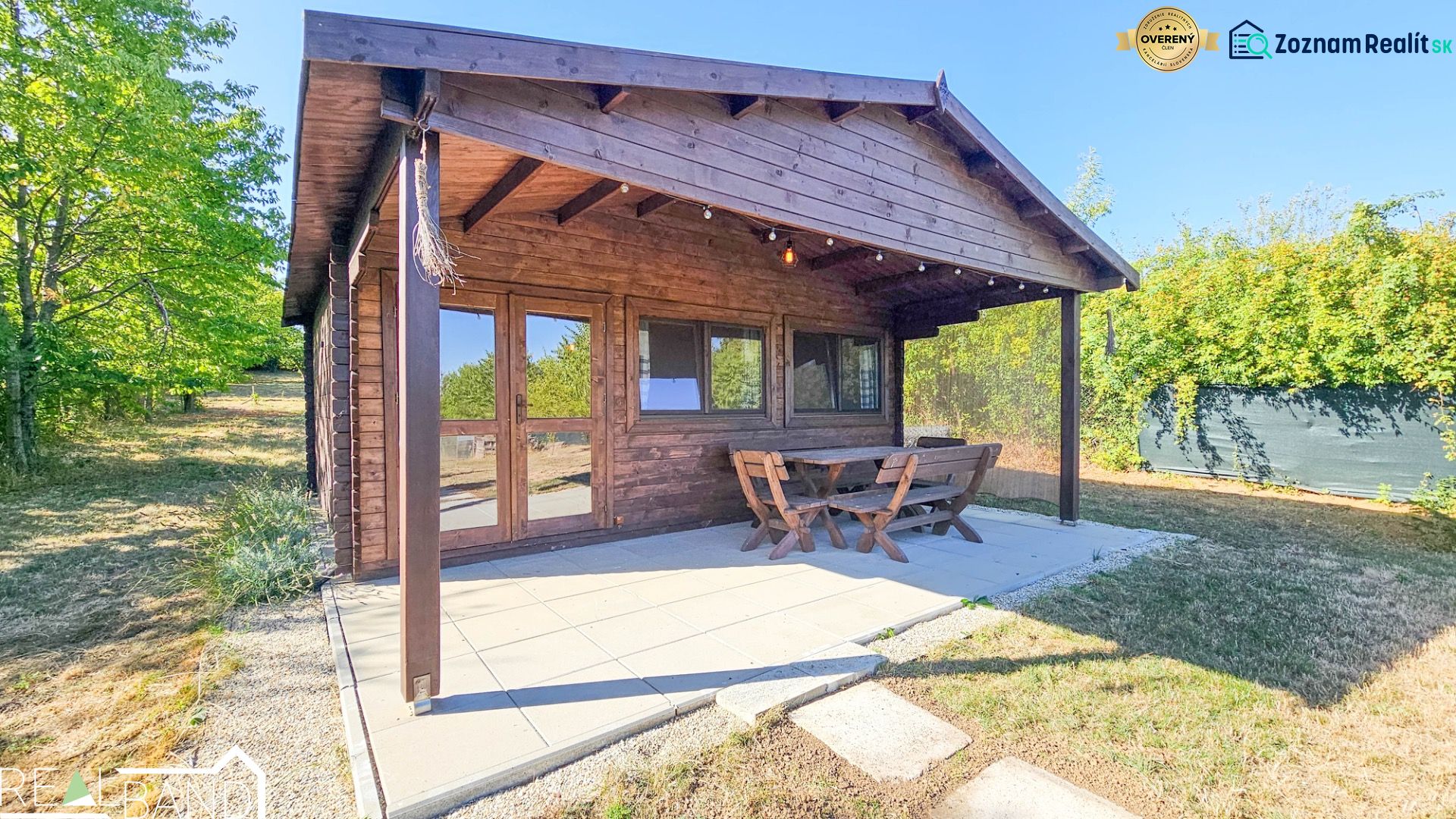 Wooden cottage in Suchá nad Parnou with outdoor seating in a landscaped yard.