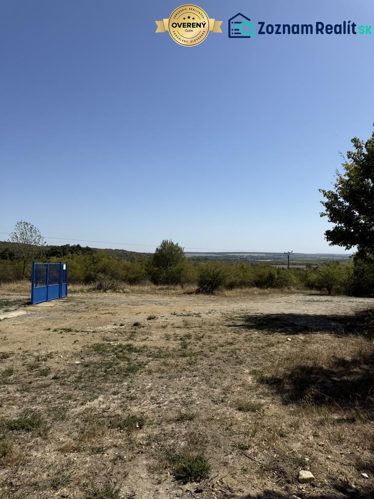 Agricultural and forest lands in Pezinok, Kučišdorfská Street, with a blue entrance gate.