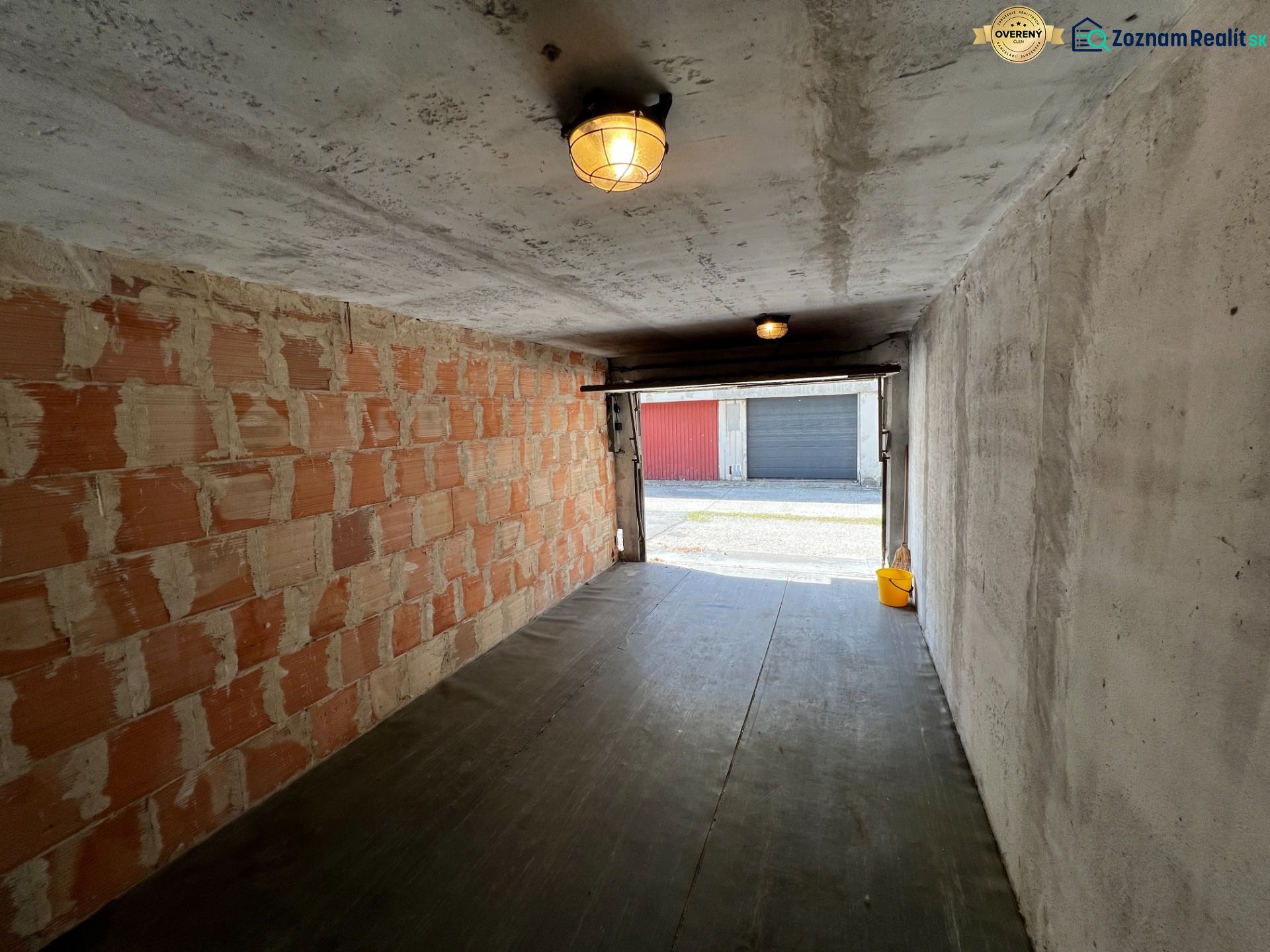 The interior of a garage with unfinished walls and a floor with a wooden decor.