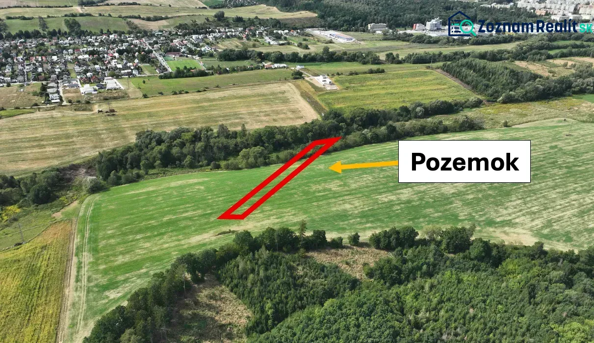 Agricultural and forest lands in the Žilina area with nearby urban developments and greenery.