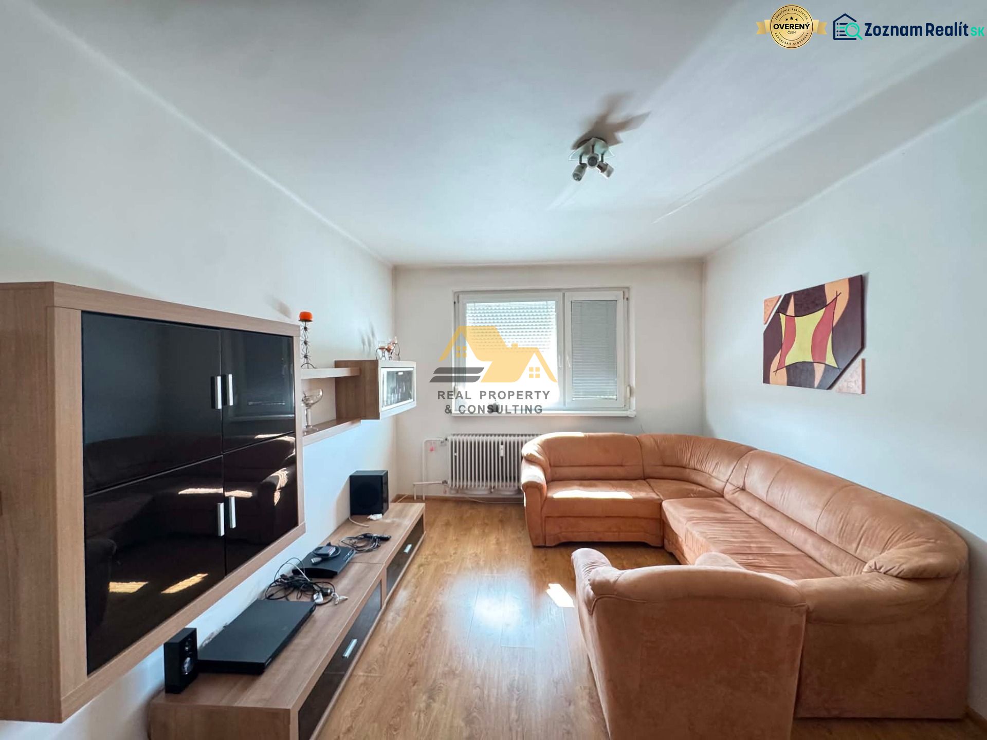 Living room with a light sofa, furniture, and flooring with a wood decor in a 3-room apartment.