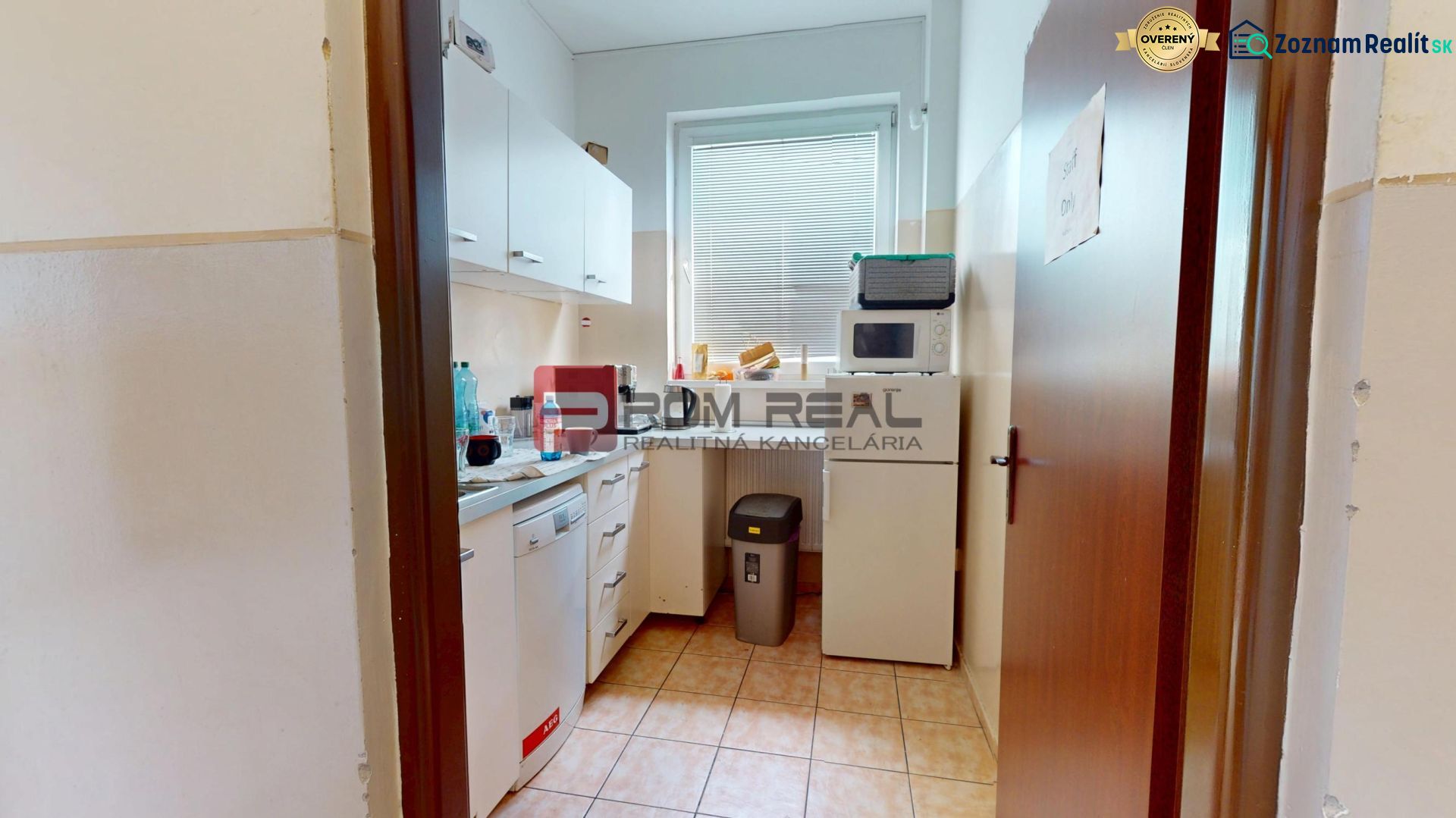 Offices with a furnished kitchenette, including appliances and storage space.
